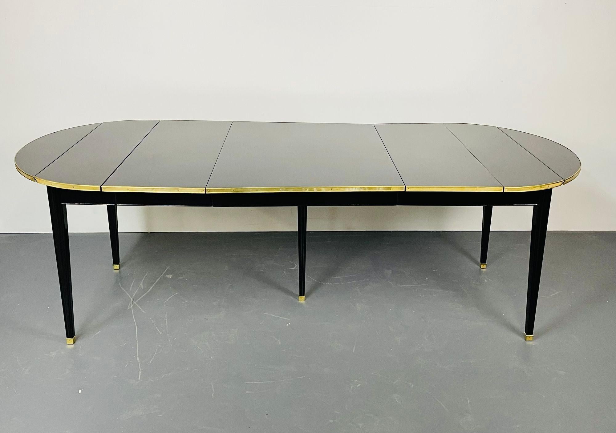 A Circular Dining Table, Hollywood Regency, Maison Jansen Style, Functional

A stunning dining table in the fashion of Jansen having drop sides and three leaves. This very versatile dining table collapses to a diminutive 38 by 20 inches and