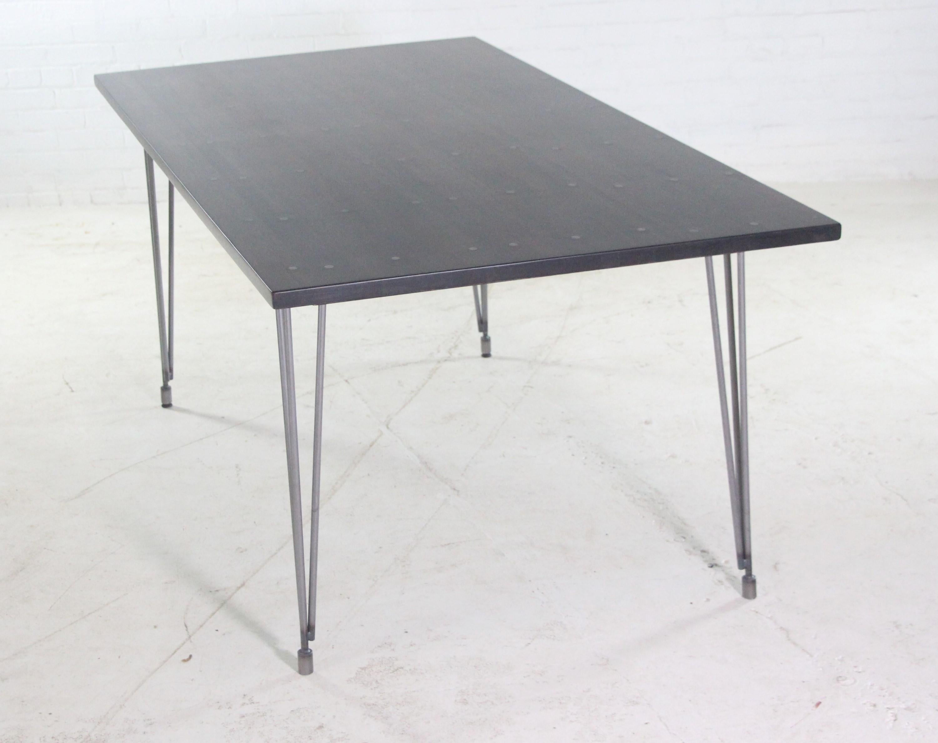Handmade industrial flooring oak tabletop in an ebony stain paired with hairpin legs. This table is ready to ship. Please note, this item is located in our Los Angeles location.