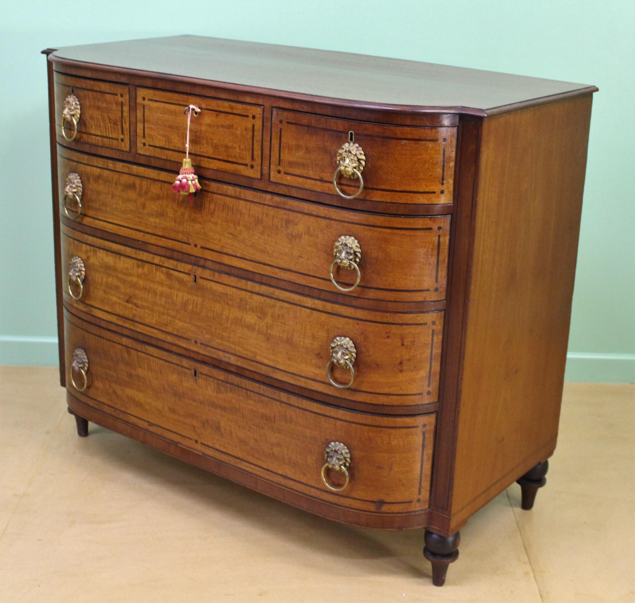 An imposing Regency period mahogany chest of drawers. Of excellent construction in solid mahogany, mahogany veneers and with oak drawer linings. Of generous proportions and of D-fronted form and with ebonized inlaid detailing throughout. With an