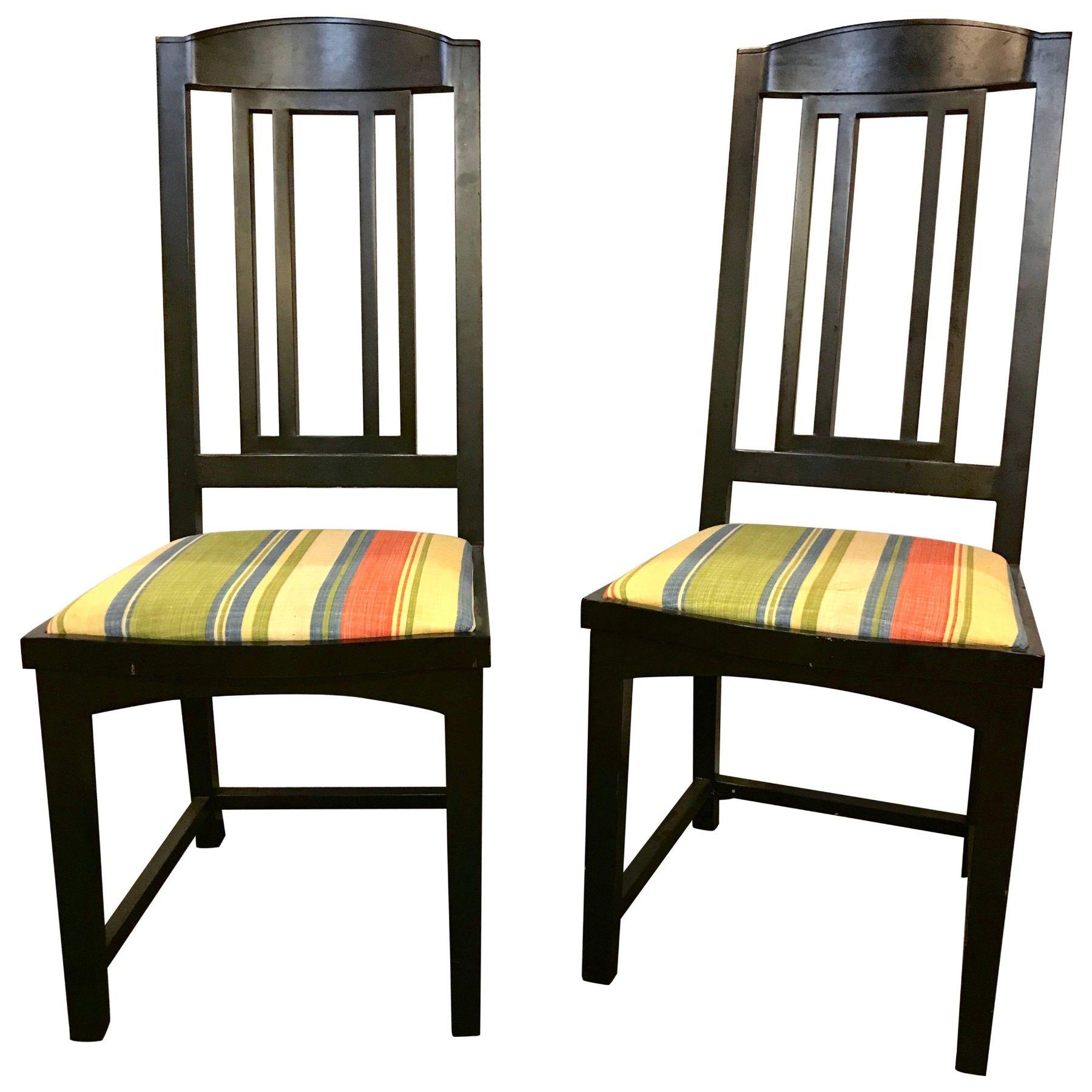 A set of 4 slat back ebony side or dining chairs from Pace Modern collection each having long sleek backrests on stripped upholstered seats. Can purchase two. There are stains on the upholstery.