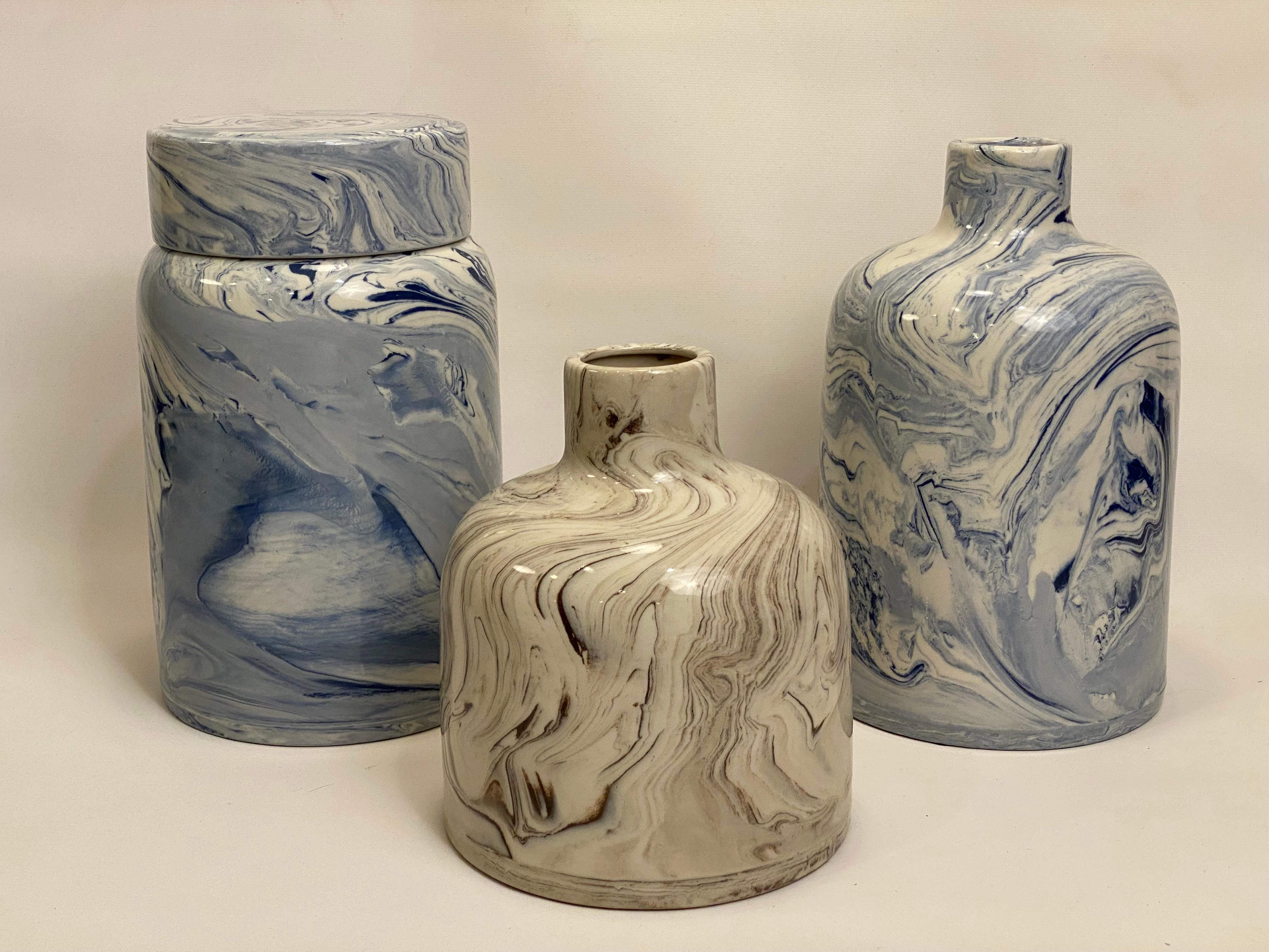 A grouping of three marbleized ceramics vessels. These pieces preserve the art and technique of the old Turkish tradition of paper marbeling and other surfaces. Circa 1980-90. The large blue vase retains a partial label. These are in good overall