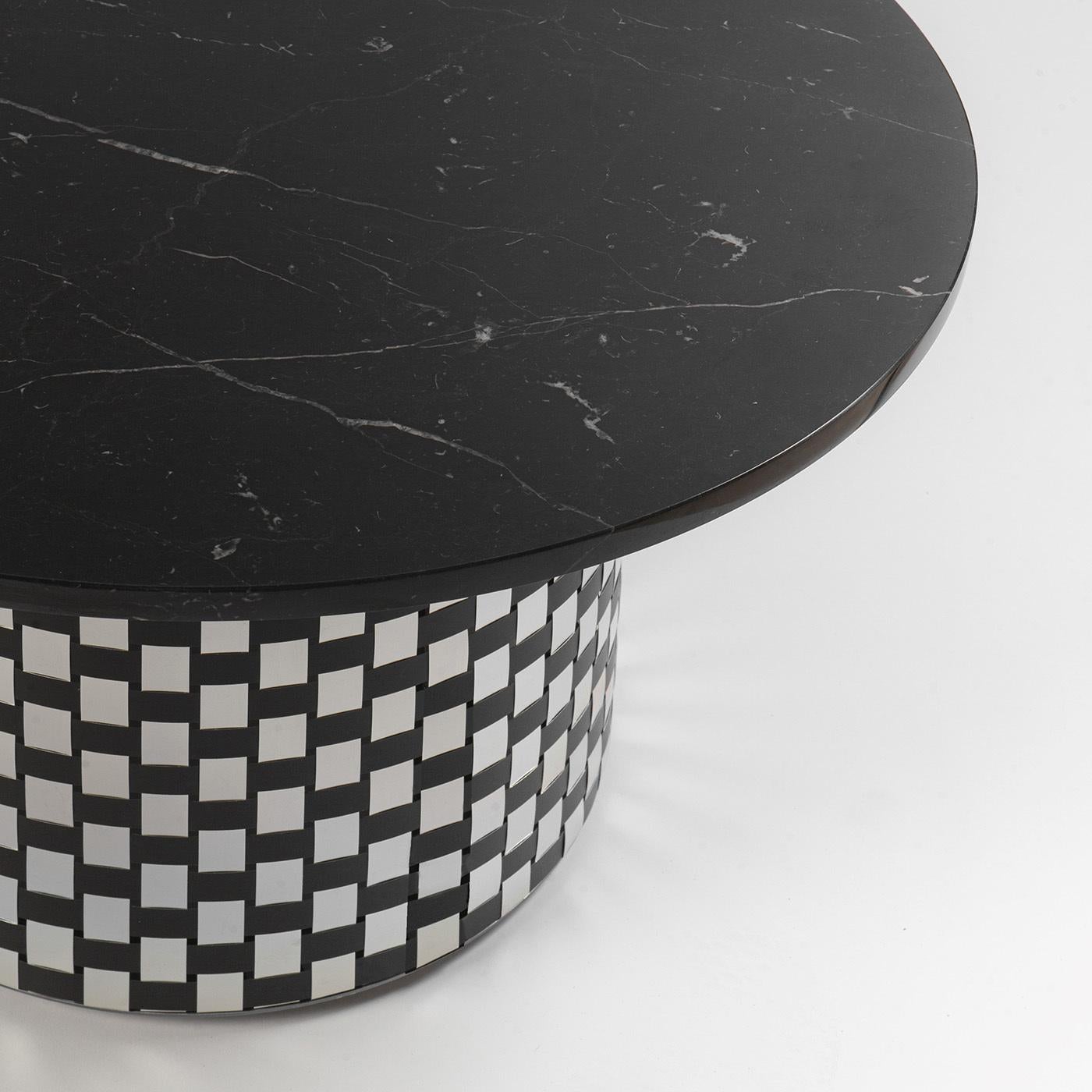 Named after Hecate, the Greek goddess of magic and the night, this coffee table is marked by a striking combination of elegant and dark hues, contrasting textures, and refined materials. Inspired by the Optical Art movement of the 1960s, it rests on