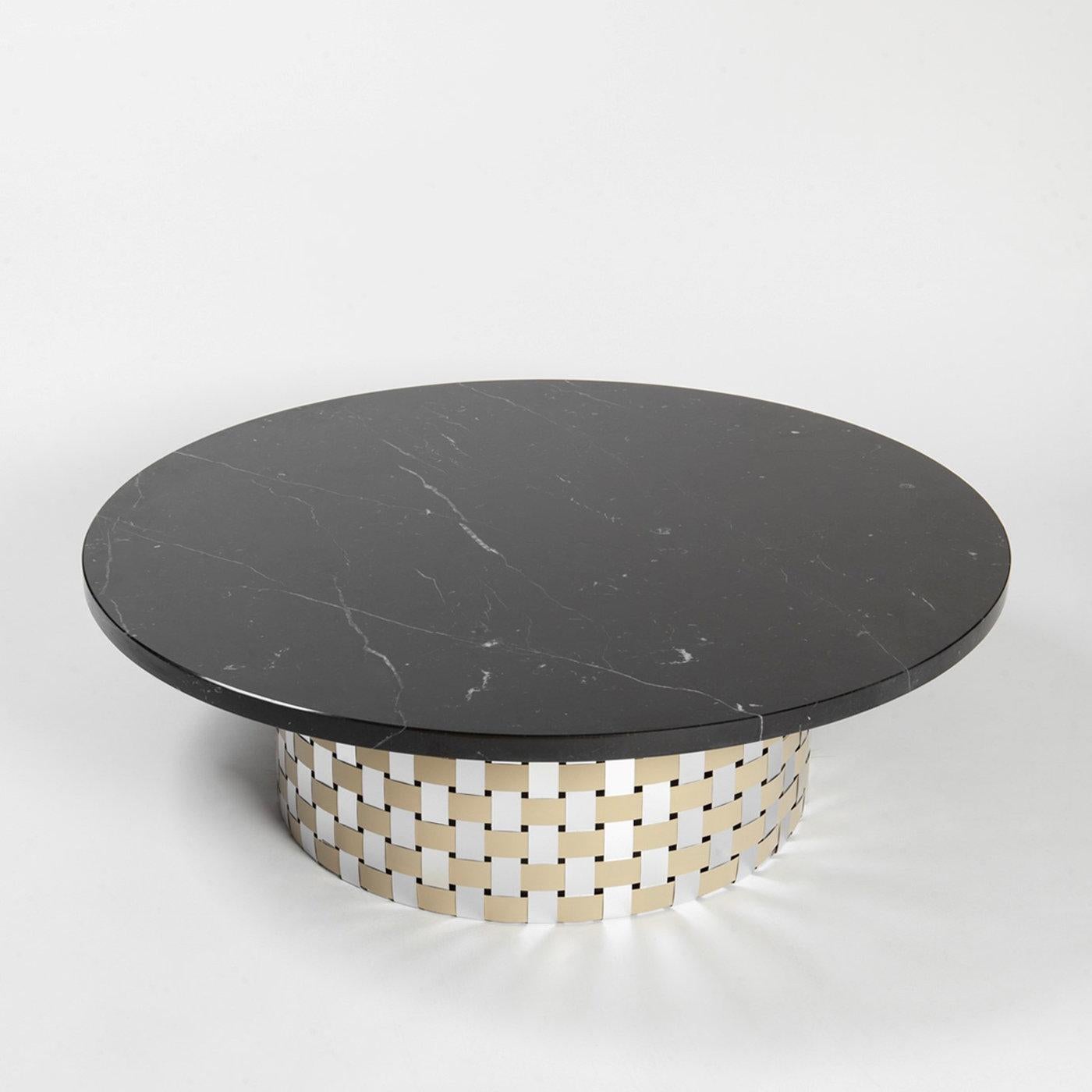 Named after Hecate, the ancient Greek goddess of the waning moon, this round coffee table will make a stately statement in any decor. The cylindrical base equipped with tiny wheels is composed of recycled foils of natural-finished and golden