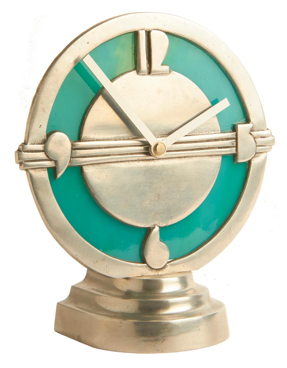 This wonderfully eccentric American Art Deco aluminum and green slag glass illuminated electric clock could be a studio or even a Trench Art piece. Either way I think that it is brilliant! The aluminum bezel with its wonderful extreme Art Deco style