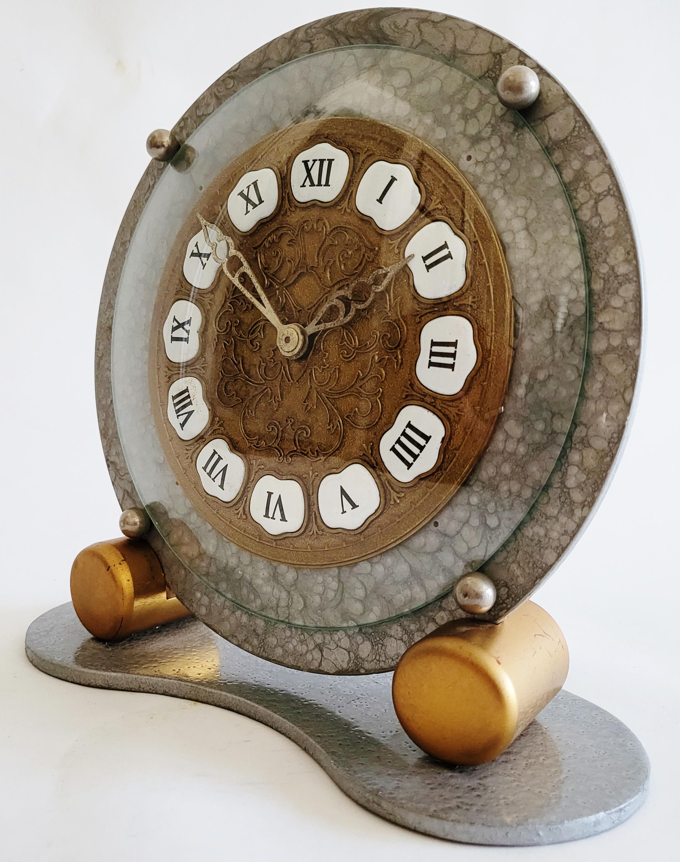 This eccentrically designed English mechanical table clock is by the celebrated London clockmakers, Davall of Clerkenwell. Its design is a combination of geometric Art Deco with Baroque flourishes!! The floral brass clock face and painted porcelain