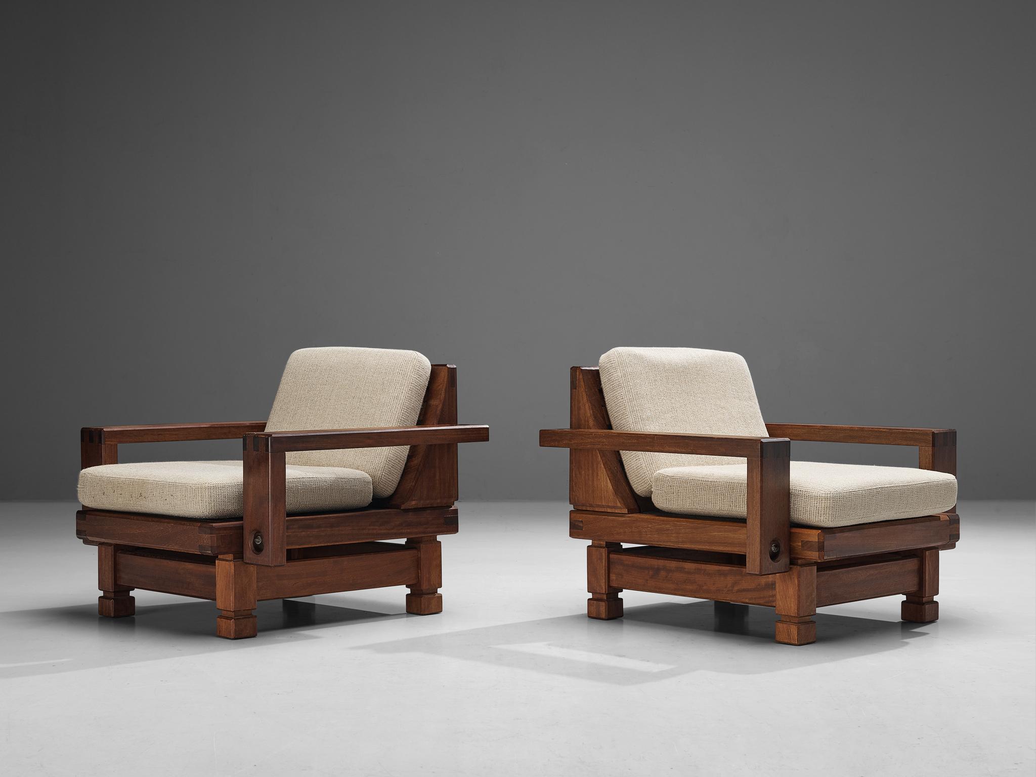 Pair of lounge chairs, teak, okoume, fabric, France, 1960s.

The design conceals an evolved rustic character with great quality of elegance. This is discernible in the wooden frame executed in teak which is based on a construction of sharp