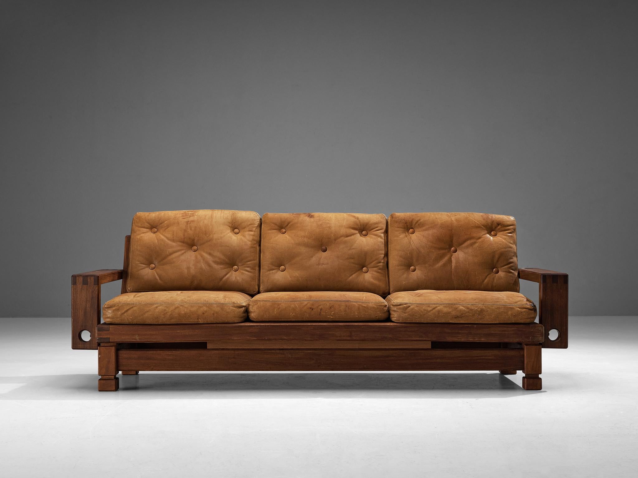 Sofa, teak, leather, France, 1960s

A French sofa defined by a pronounced geometric structure of clear lines and distinctive carvings. The wide armrests are detailed in a subtle manner holding well-proportioned apertures and the legs are
