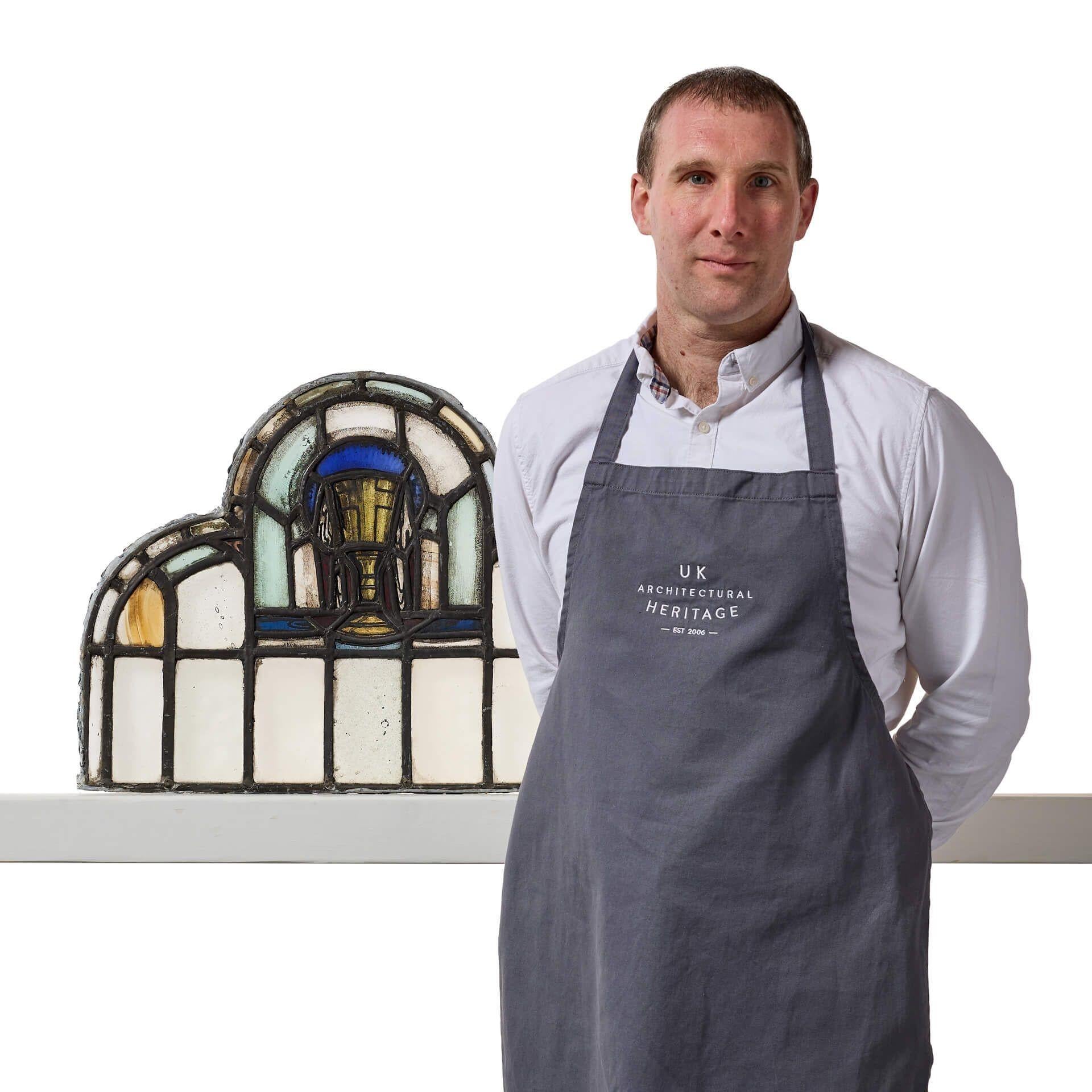A simple yet elegant antique ecclesiastical multi-arched stained glass panel depicting a stylised chalice.
 
Though it dates from the early 20th century, this will make a stunning feature above a porch or dividing door in properties traditional and