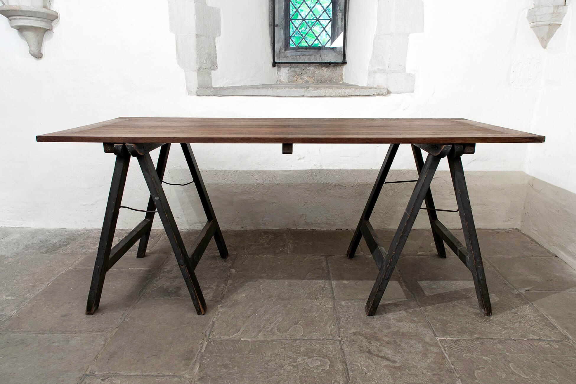 A striking ecclesiastical oak trestle table, with decorative engravings to the tabletop. Fabulous colour and patina to the top and trestle legs. Unrestored and in wonderful condition, having spent the majority of its life in a church. 
British,