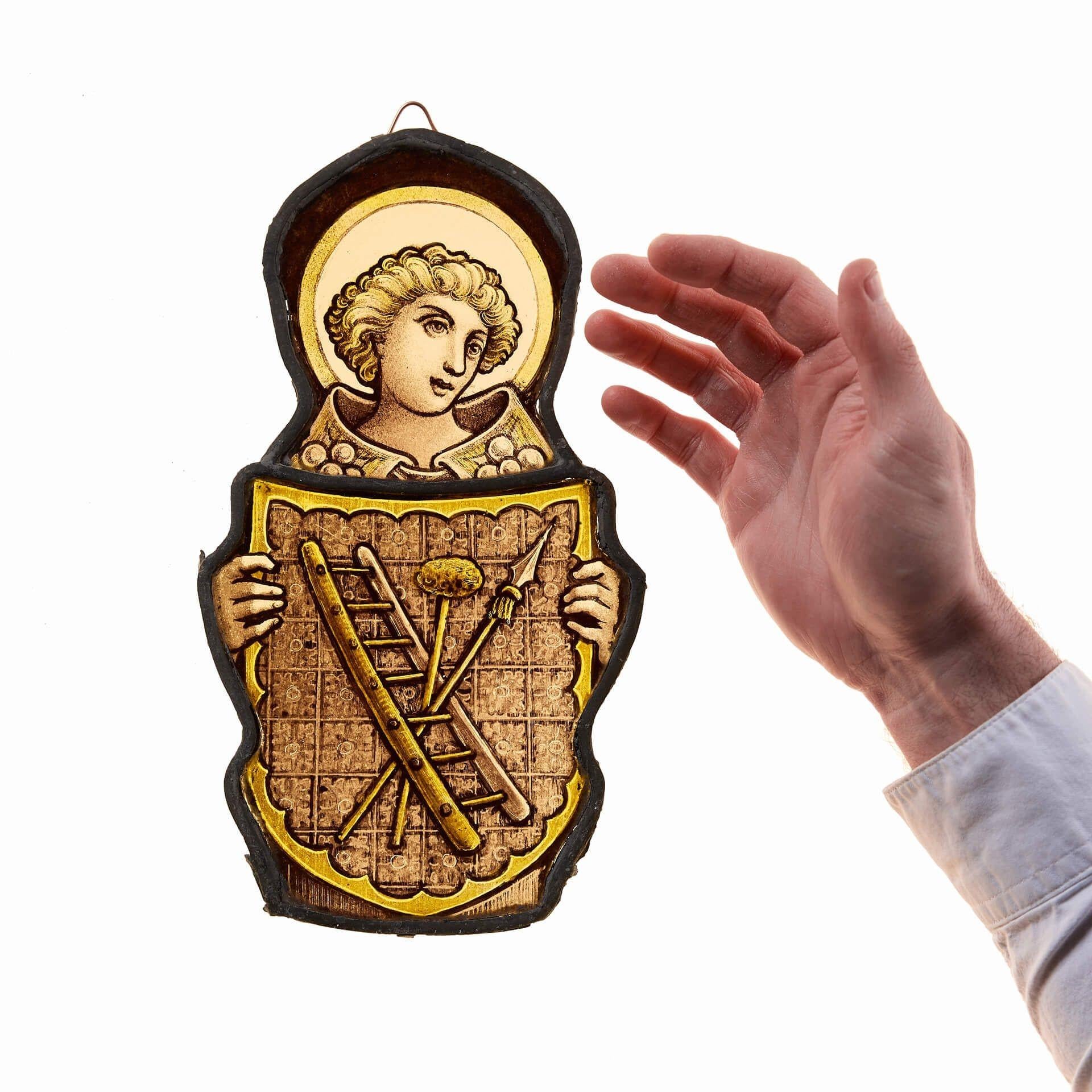A small antique stained glass window hanging of an ecclesiastical figure with halo, possibly a saint or angel, circa 1870. Beautifully handpainted to create a sense of depth and expression, the ecclesiastical figure holds an armorial shield with an