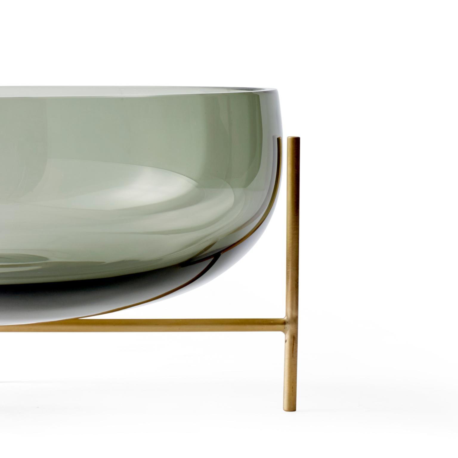 A new addition to the Echasse series by Theresa Arns for Menu, Echasse bowl combines the elegance of a traditional glass bowl with a playful and light expression, created by four slender brass legs that elevate it into the air. The word échasse is