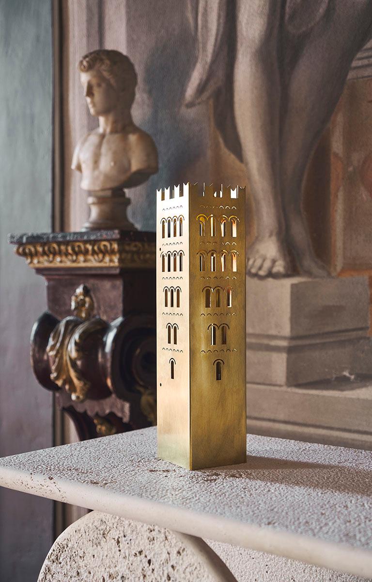 The Lucca tower is a Golden brass tower with handcrafted polishing and an elegant cotton cord with a switch. Inspired by medieval Tuscan architecture, this designer lamp strikes a perfect balance between contemporary aesthetics, history, and