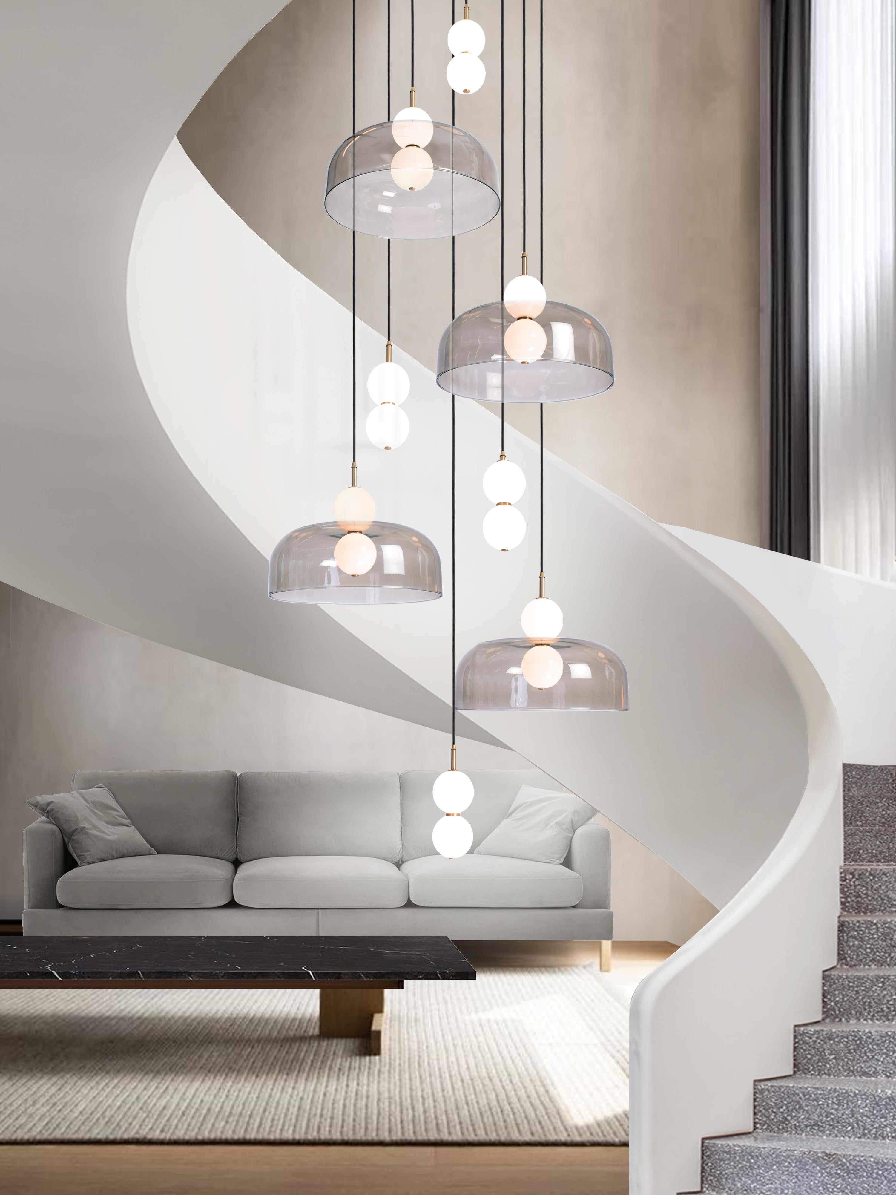 A hand spun shade suspended between white glass orbs, creating an echoed glow of light via the illusion of mirrored reflections.

Designed to be both functional and sculptural the Echo collection incorporates two pendant variations; lamp and