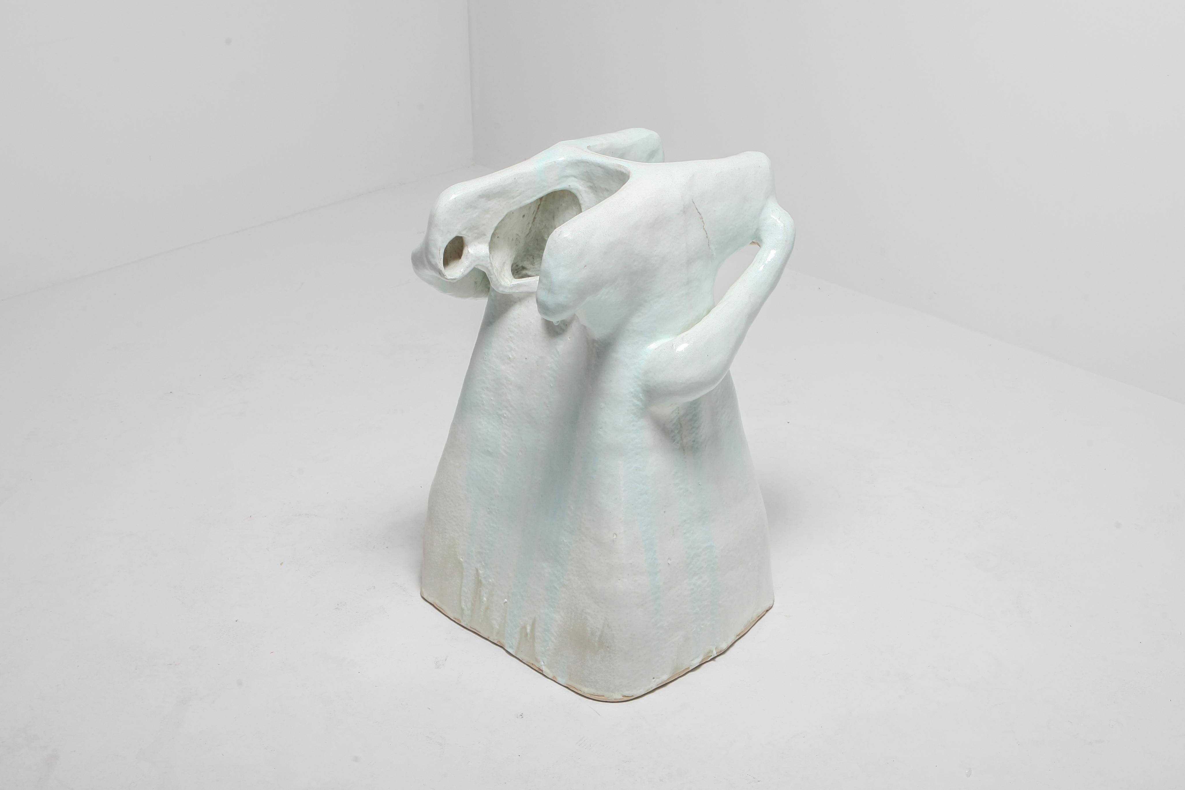 ‘Echochamber’ by Carlo Lorenzetti, 2019
Turquoise and white milky glazed stoneware
A vessel that you sit against and talk into, either by yourself or with another person.

The term “echo chamber” is used most commonly today to described a closed