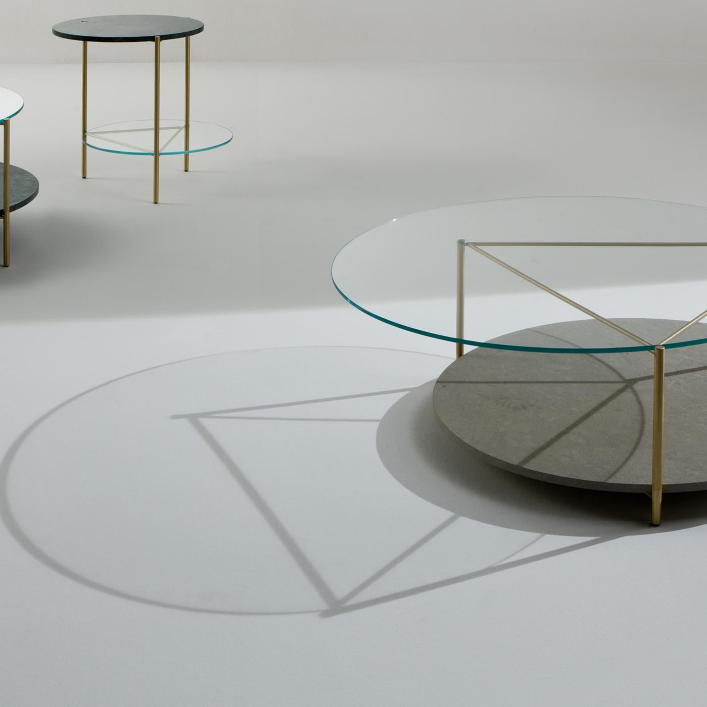 Echo tables allow the customer to create unique combinations with one of two shelves in different marble varieties depending on their individual taste and creativity. This dynamic and sophisticated Echo Coffee Table is crafted in satin brass with