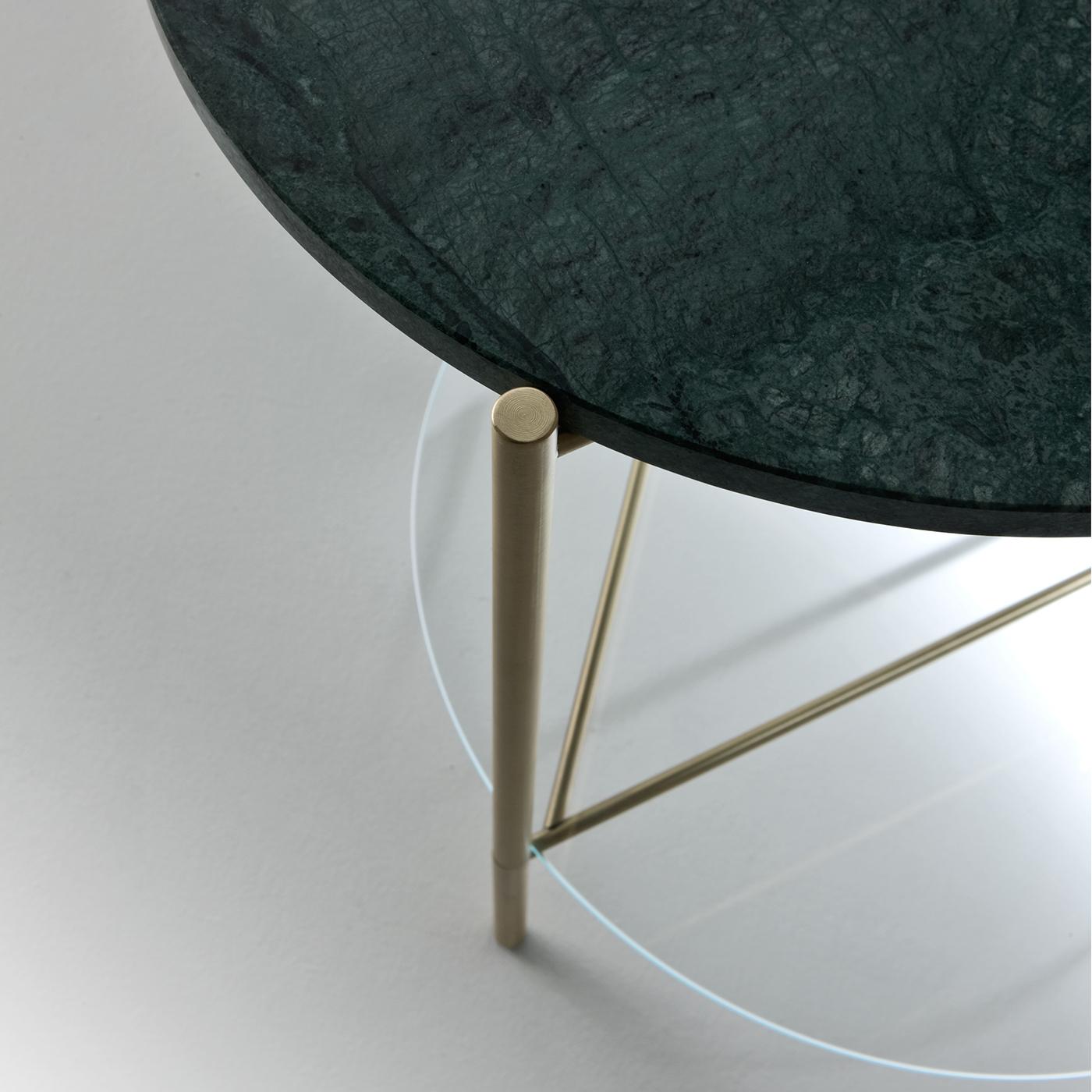 La table d'appoint Echo, simple et élégante, est fabriquée en laiton satiné, avec une étagère inférieure en verre extralight et un plateau en marbre vert Guatamala poli mat. Les tables Echo sont disponibles avec une ou deux tablettes dans