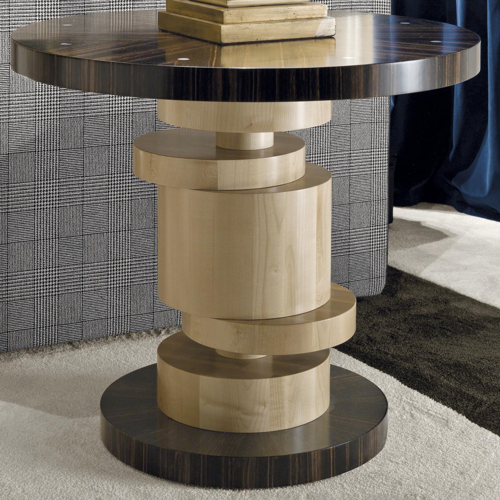 Creating a unique impression of movement, the structure of this exquisite side table will make a statement in a contemporary living room. The round base and top in mahogany strikingly contrast with the honey-colored maple of the vertical structure,