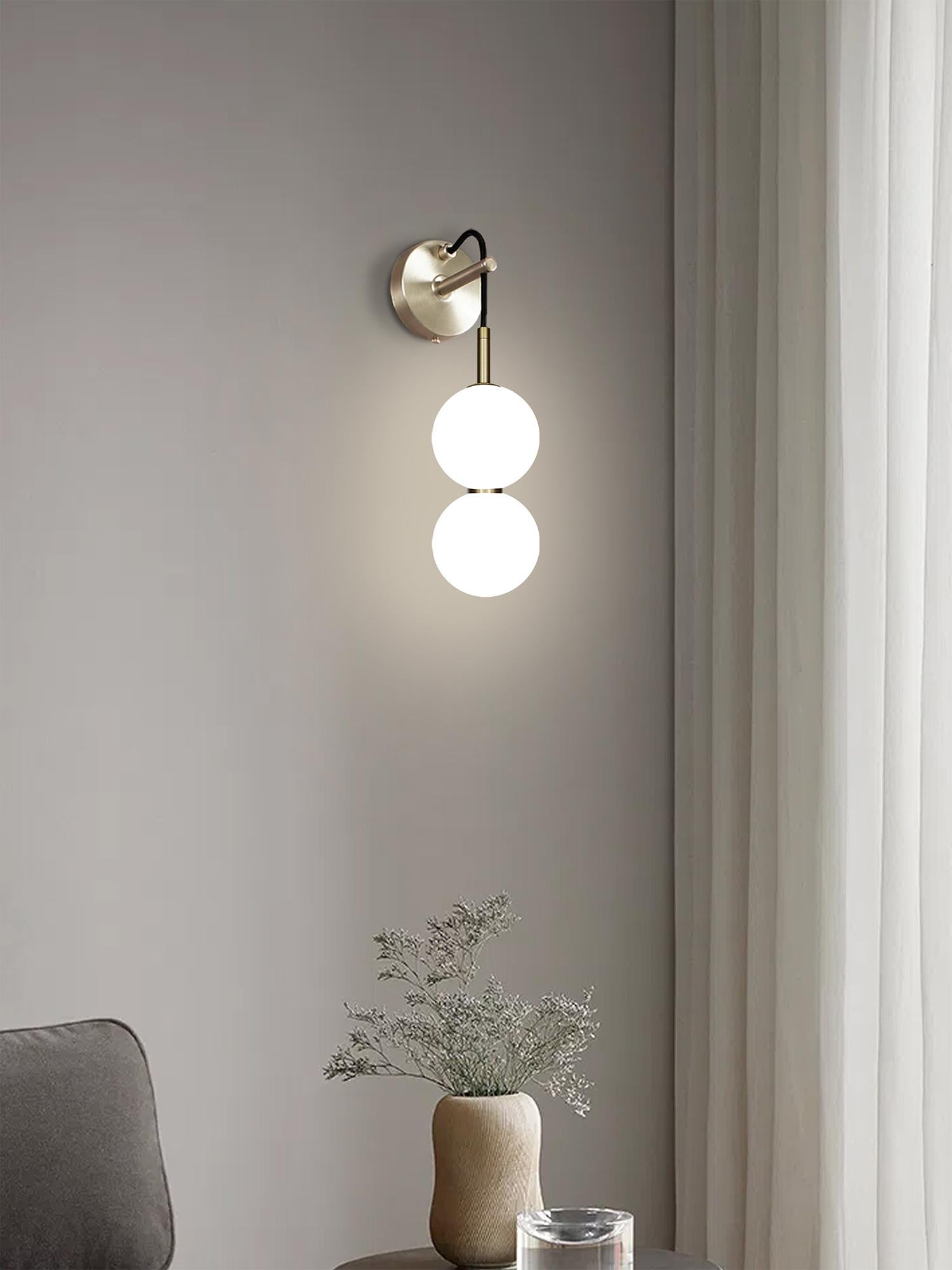 Two delicate white opaline glass orbs stacked on top of one another to create an echoed glow of light and the illusion of subtle reflections.