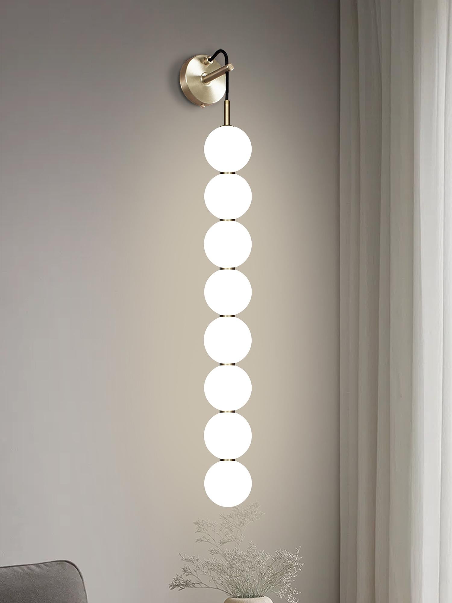 Two delicate white opaline glass orbs stacked on top of one another to create an echoed glow of light and the illusion of subtle reflections.