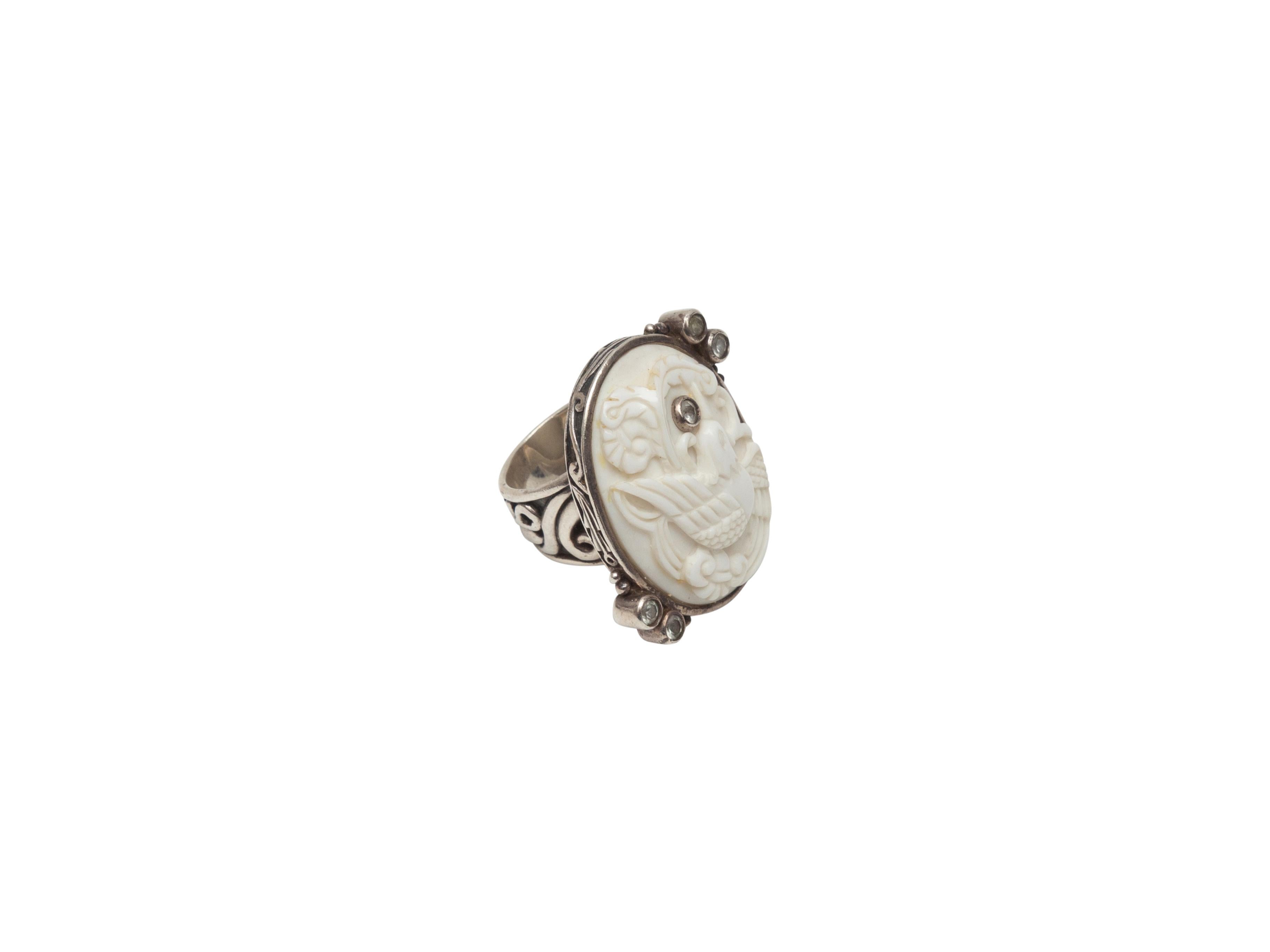 Product details: White and sterling silver carved bird ring by Echo of the Dreamer. Crystal adornments at top and sides. 1.5