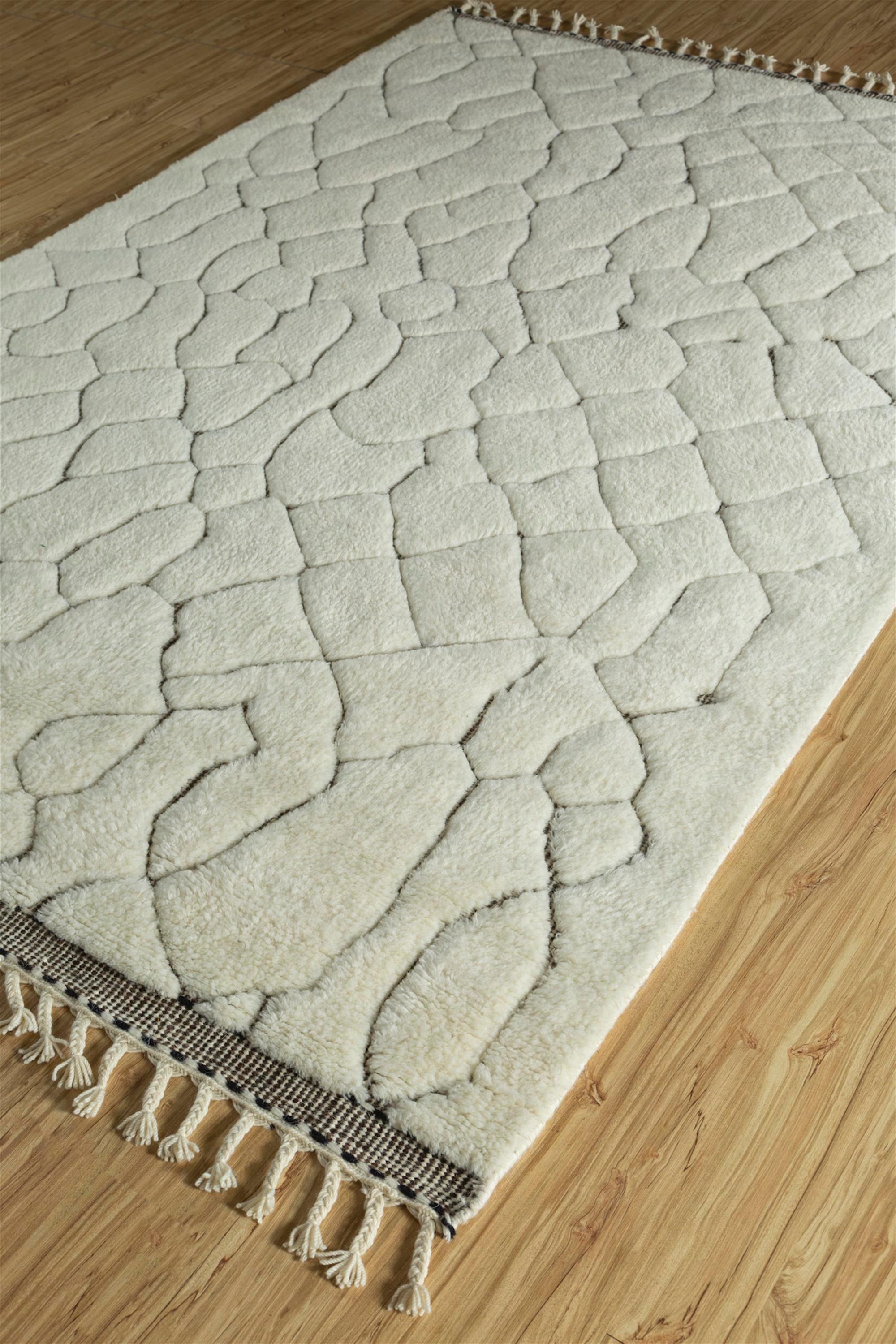 Ever wondered how traditional Moroccan patterns could blend seamlessly with modern aesthetics? Behold this hand-knotted marvel, a fusion of heritage and contemporary allure. Crafted from sumptuous handspun wool, its plush texture invites touch.