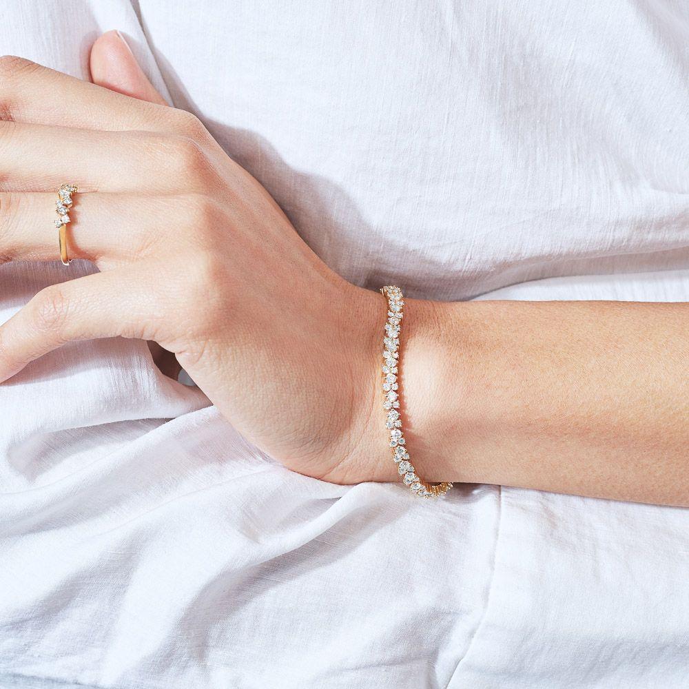 Diamonds in bloom. This Ecksand interlocking diamond bracelet is a unique piece of jewelry. It features a row of interlocking ethical diamonds set throughout. It's handcrafted from high-end sustainable gold for lifetime wear. This delicate diamond
