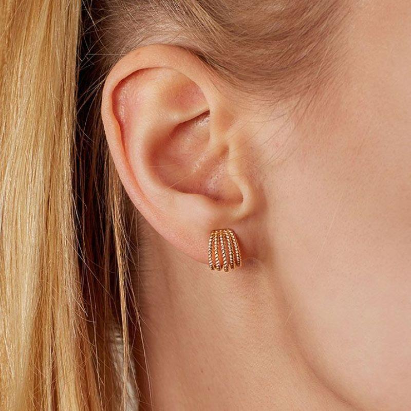 Golden tresses. These Ecksand Tresses earrings revisit the art of twisted gold. These hoop earrings feature four bands of braided recycled gold. They are cast in classic yellow gold for lifetime wear. The perfect everyday gold hoops with a