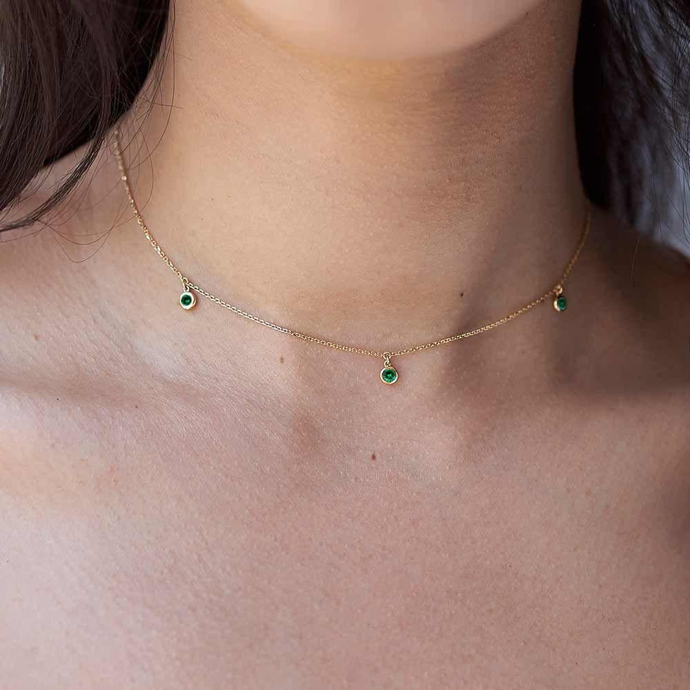Life is better with colour. This Ecksand Showcase necklace will add a pop of colour to your look. This choker necklace features three natural green emeralds. The round cut of the emeralds lends this necklace a classic vibe. This gemstone necklace is