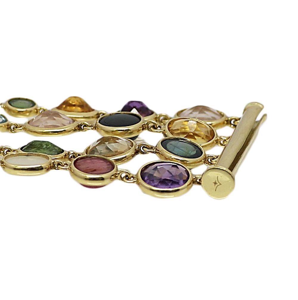 Eclat 18k Yellow Gold Multi Colored Stone Bracelet. It Measures 9 Inches and weighs 61.2 Grams. The Multi Colored Stones Include Pink And Green Tourmalines, Dyed Chalcedony, Garnets, Amethysts, Quartz, and Aquamarines.