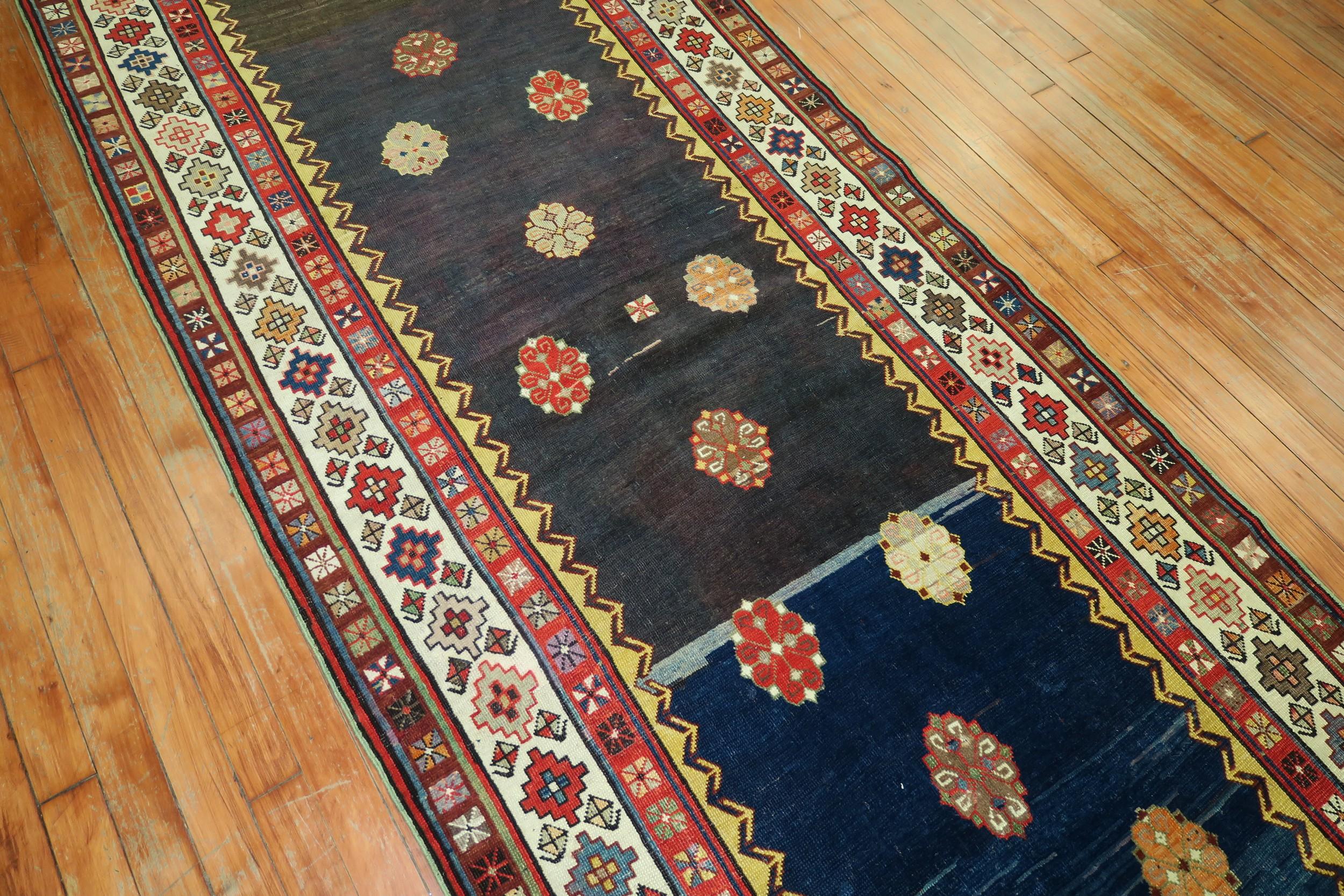 An eclectic Talish runner with a striated blue and navy ground surrounded by a colorful geometric border. The quality is very good. It’s a dramatic runner that would add a new soul to any given hallway, circa 1900

Measures: 3'6” x 9'2”

Talish