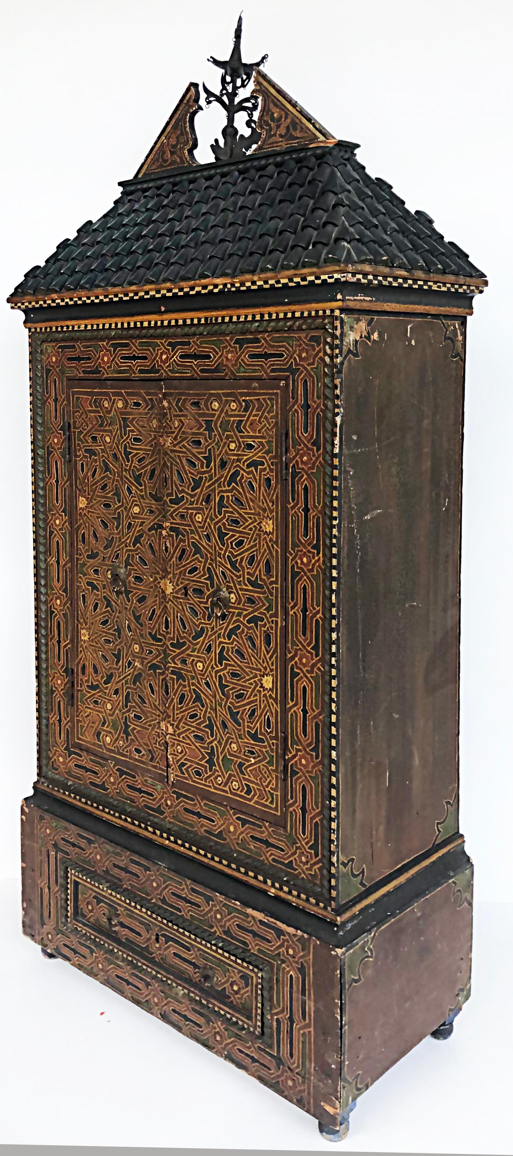 Eclectic Antique Asian polychrome wood cabinet, embellished roof

Offered for sale is an antique Asian polychrome-painted diminutive wood cabinet with a carved embellished rooftop adorned with a broken pediment and iron weathervane. Two carved
