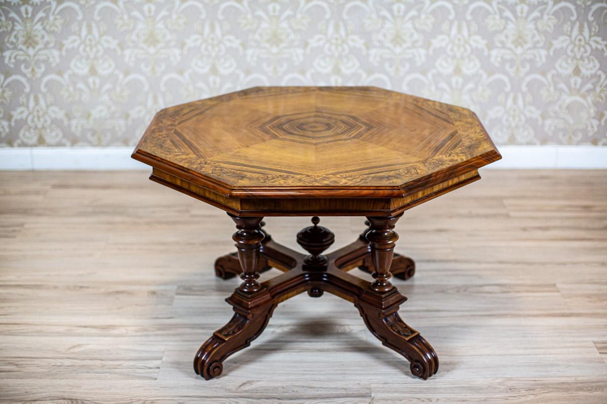 Light Brown Eclectic Center Table from the Late 19th Century in Shellac

We present you this Eclectic walnut table from Q4 of the 19th century.
The eight-sided top is covered with geometrically layered different types of veneer.
The base is placed