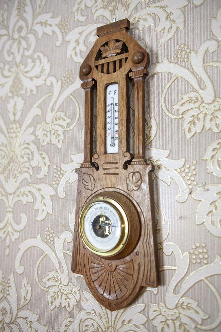 Eclectic Dutch Barometer With Thermometer From the Early 20th Century

An original barometer and thermometer set in an oak wood frame. The thermometer is calibrated in both Celsius and Fahrenheit. The casing is adorned with delicate woodcarving.