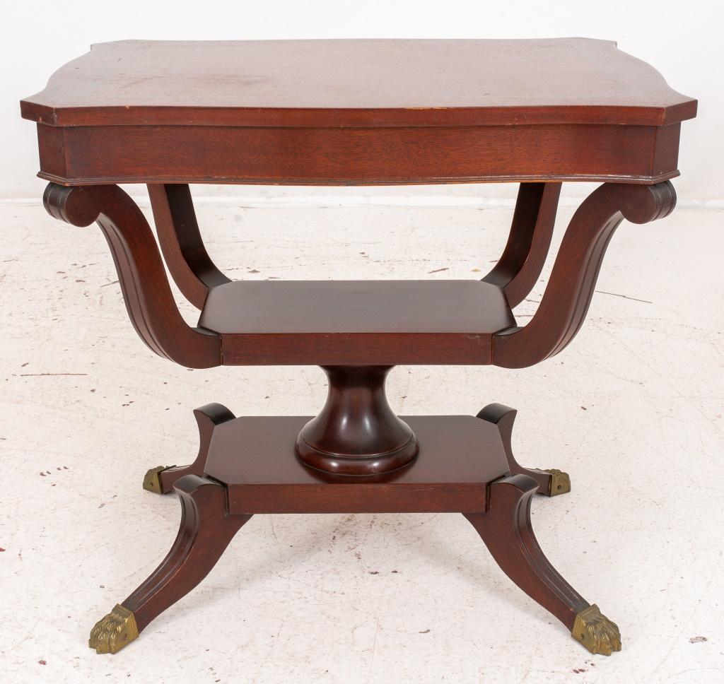 Eclectic style inlaid mahogany side table, with Victorian, Federal, and mid-century elements, with shaped canted rectangular top, above a cage-form support on splay feet terminating in lions' paw castors. 

Dealer: S138XX