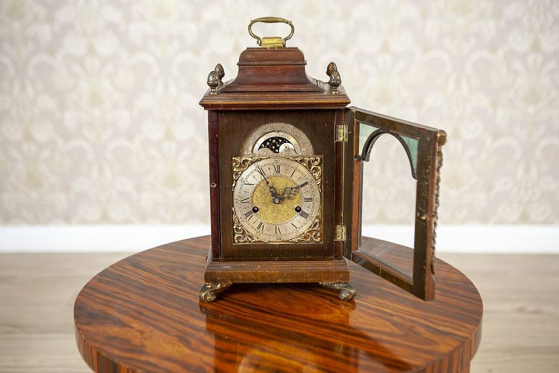 Eclectic Junghans mantel clock from the early 20th century

We present you this beautiful clock of a rich form, decorated with brass fittings and openwork ornamentation on sides. The clock is kept in original condition and bears traces of times
