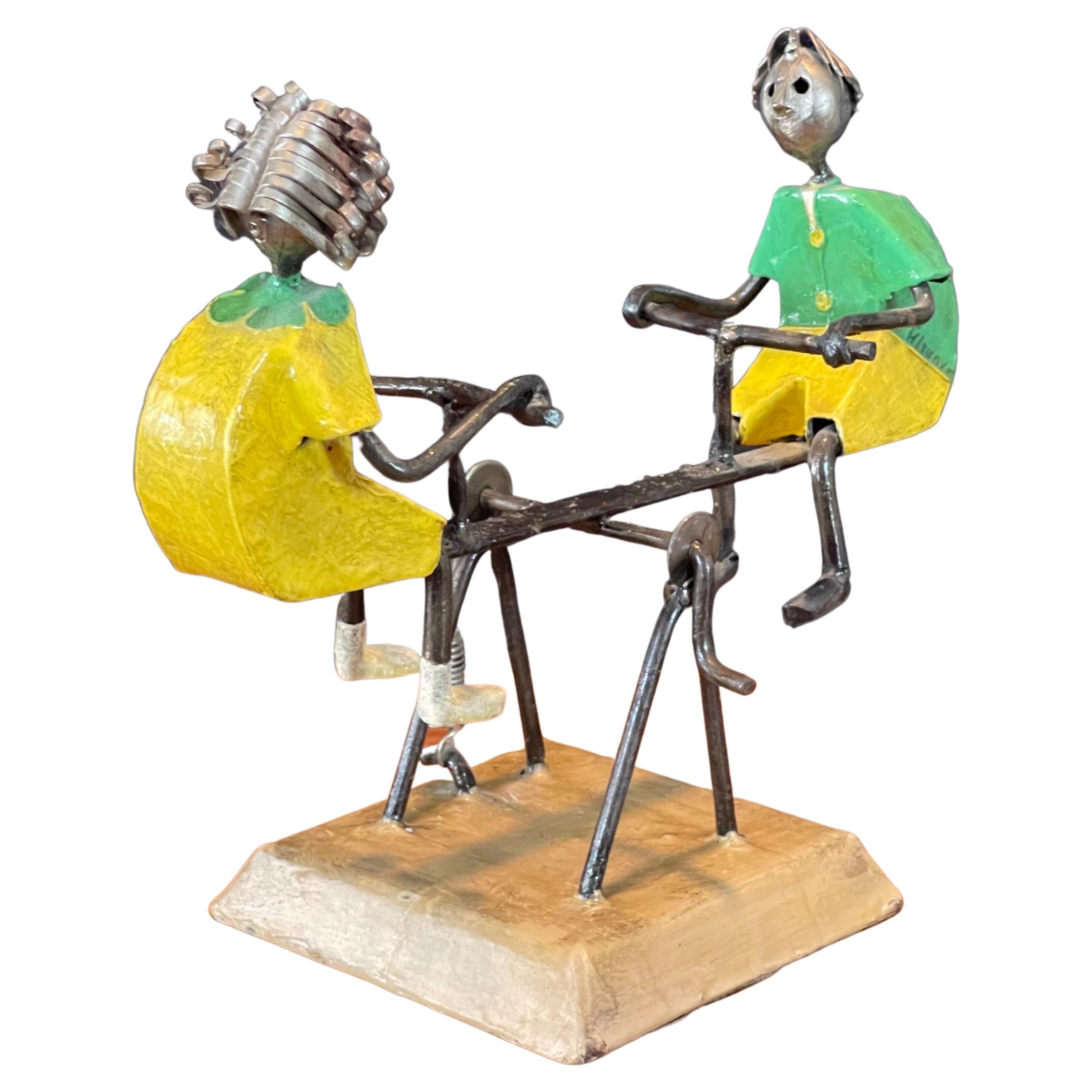 Eclectic hand painted metal see saw or teeter totter sculpture by listed Mexican artist Manuel Felguerez, circa 1970s  The sculpture has a small handle and spring mechanism that allows it to 