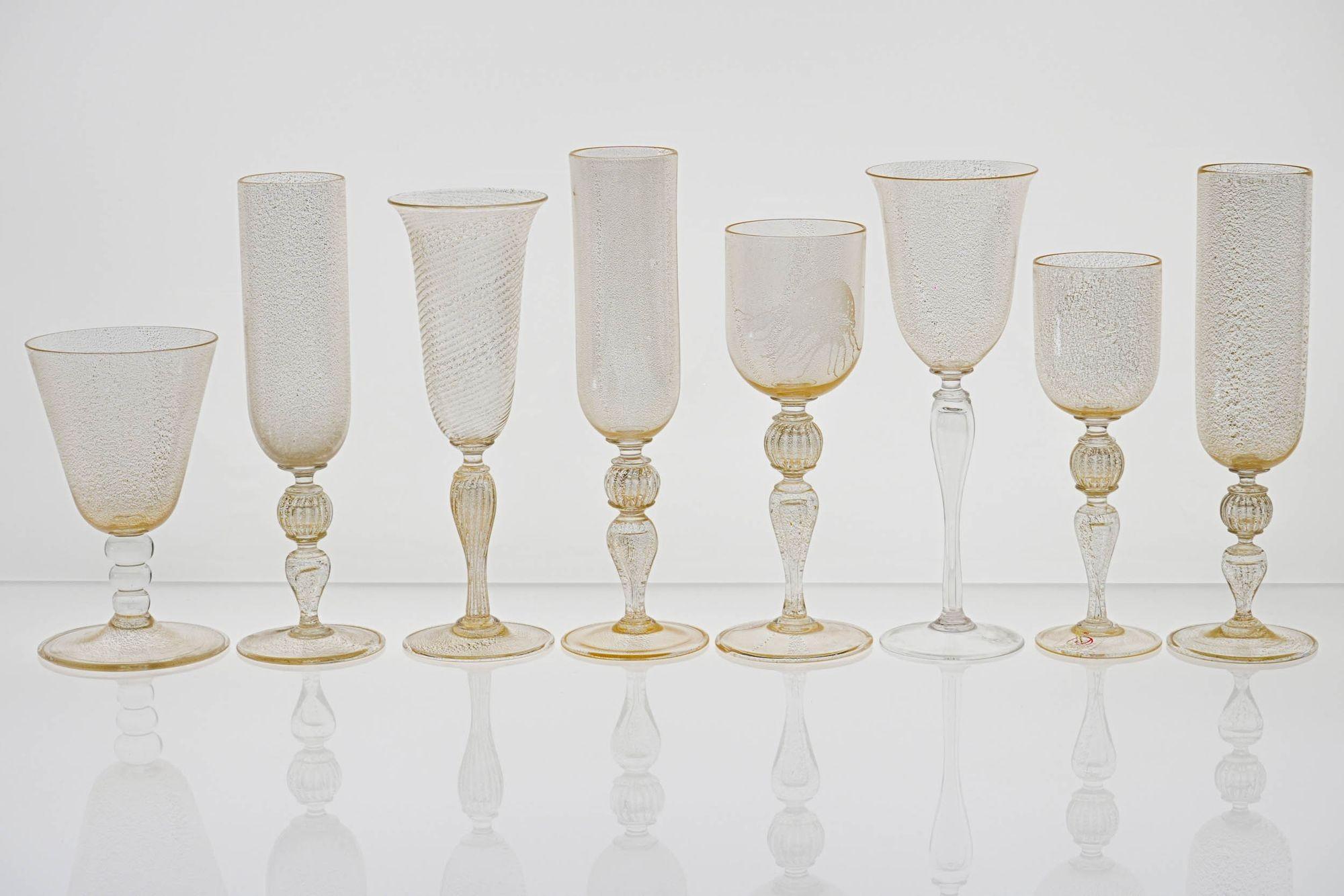 I had the privilege of gaining access to the collection of individual Cenedese glass pieces, which I am curating into eclectic sets of unique pieces.

What ties together this group of 8 stemmed glasses is to carry a 24K gold leaf embedded in the