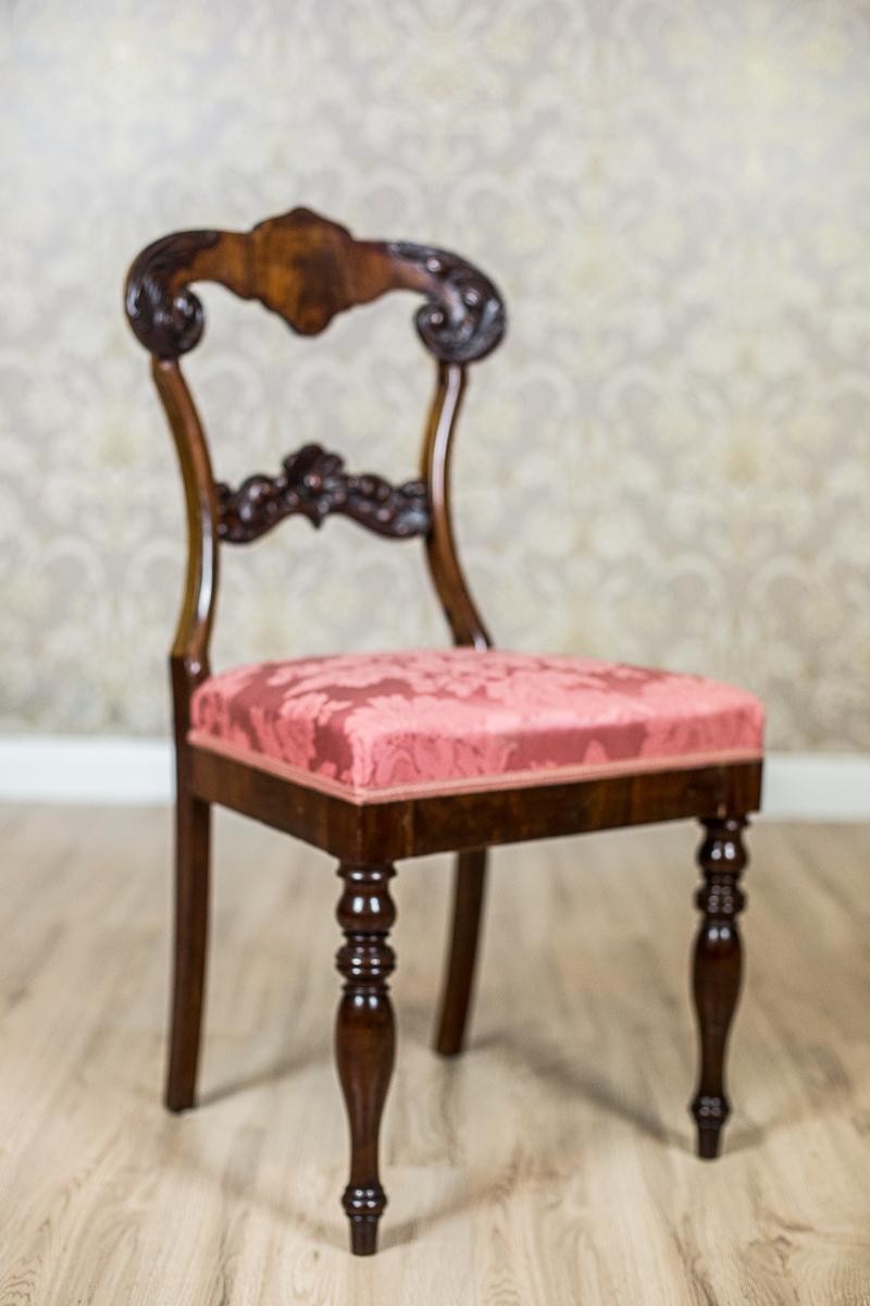 Presented chairs with upholstered seats are made in walnut wood.
The front legs are turned, the rear are straight.
The rail of the backrest and the splat are decorated with a carved, wooden appliqué.

The chairs are in good condition. They have