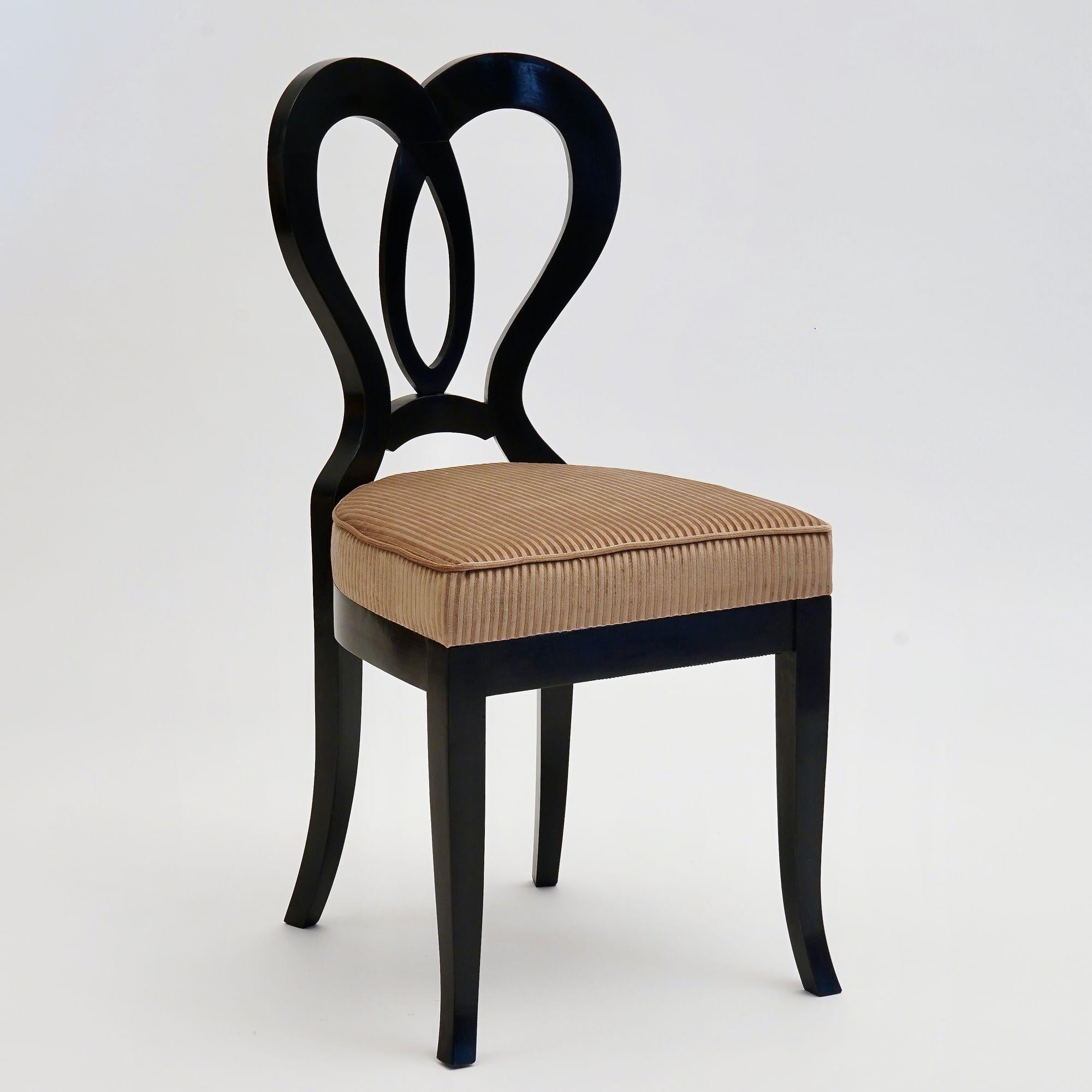 This Clara-Luise chair is one of 24 pieces in our Eclectica collection.
The chair is made of solid Italian walnut wood. The ebonized finish is applied by hand using the French polish method, creating a warm, smooth, and shiny surface.
The seat has a