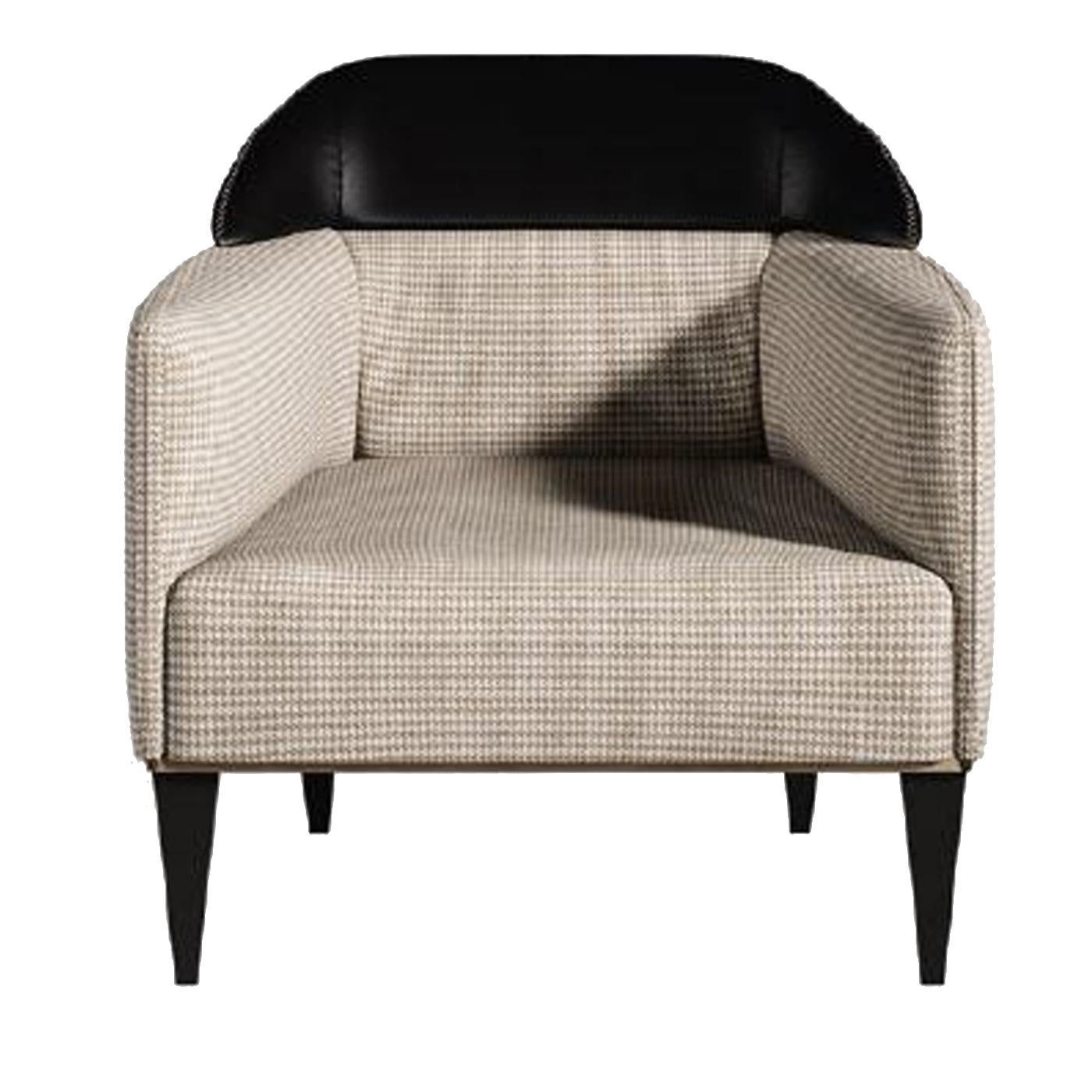 Purposefully designed to let the black leather take centre stage, the Minimalist profile of this sophisticated armchair is enhanced by the barrel arms that hug the comfortable, deep cushion seat. The dark, conical legs play off the textured ivory