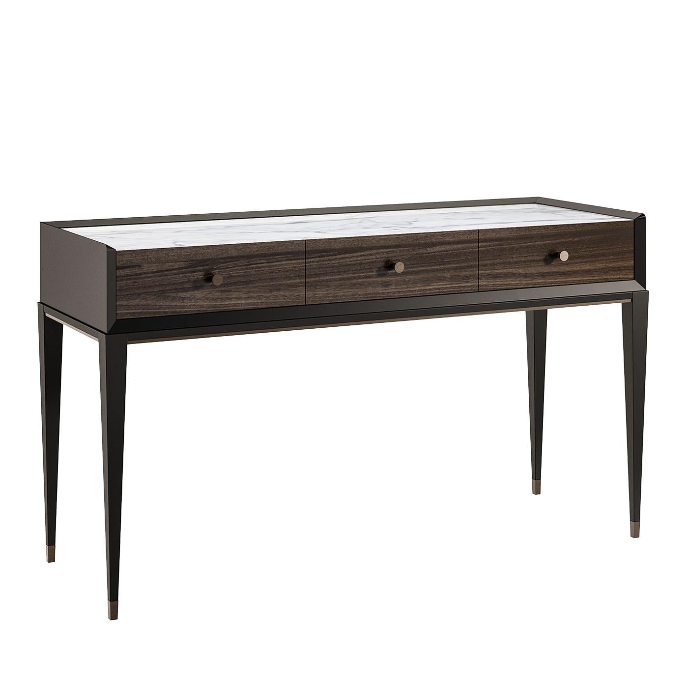The simple and clear-cut lines of this exquisite console result from impeccable construction and craftsmanship and exudes timeless elegance. The black wooden frame with its sharp, bevelled edges is supported by four slender feet accented with metal