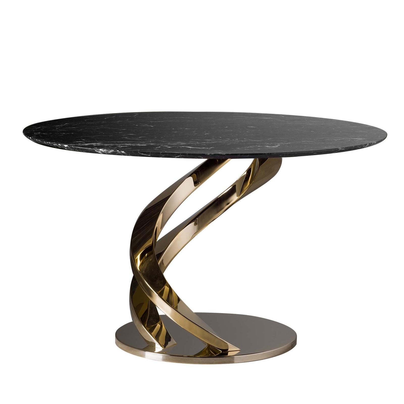 This stunning dining table is the epitome of elegance with its structure in stainless steel covered in 24-karat glossy gold comprising a series of spiraling elements that add dynamism to the composition and function as support for the round black