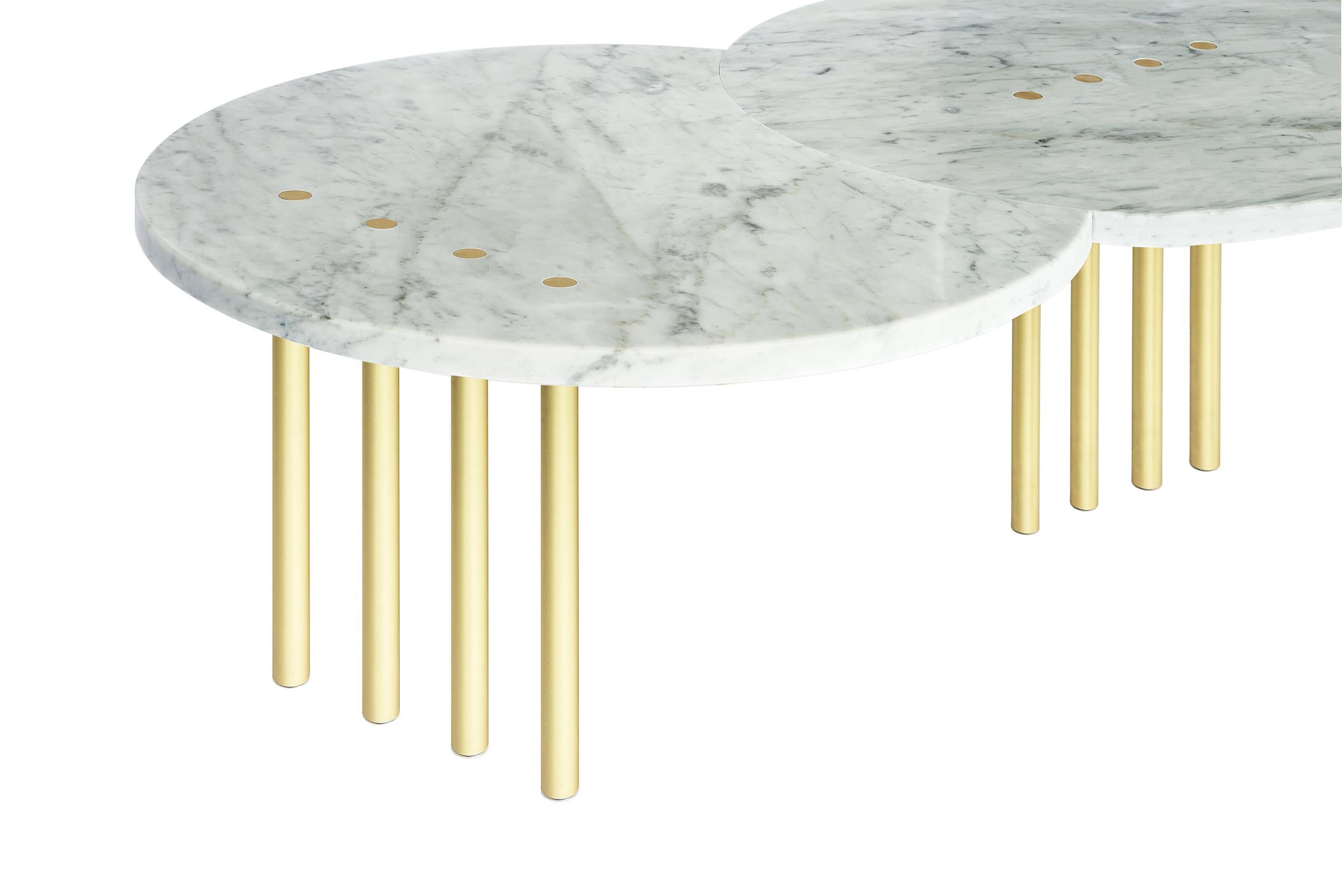 Expanding on the ?Eclipse? table series, this coffee table features a moon form of white Carrera marble. 

The slim tubular legs are made of solid brushed brass.
