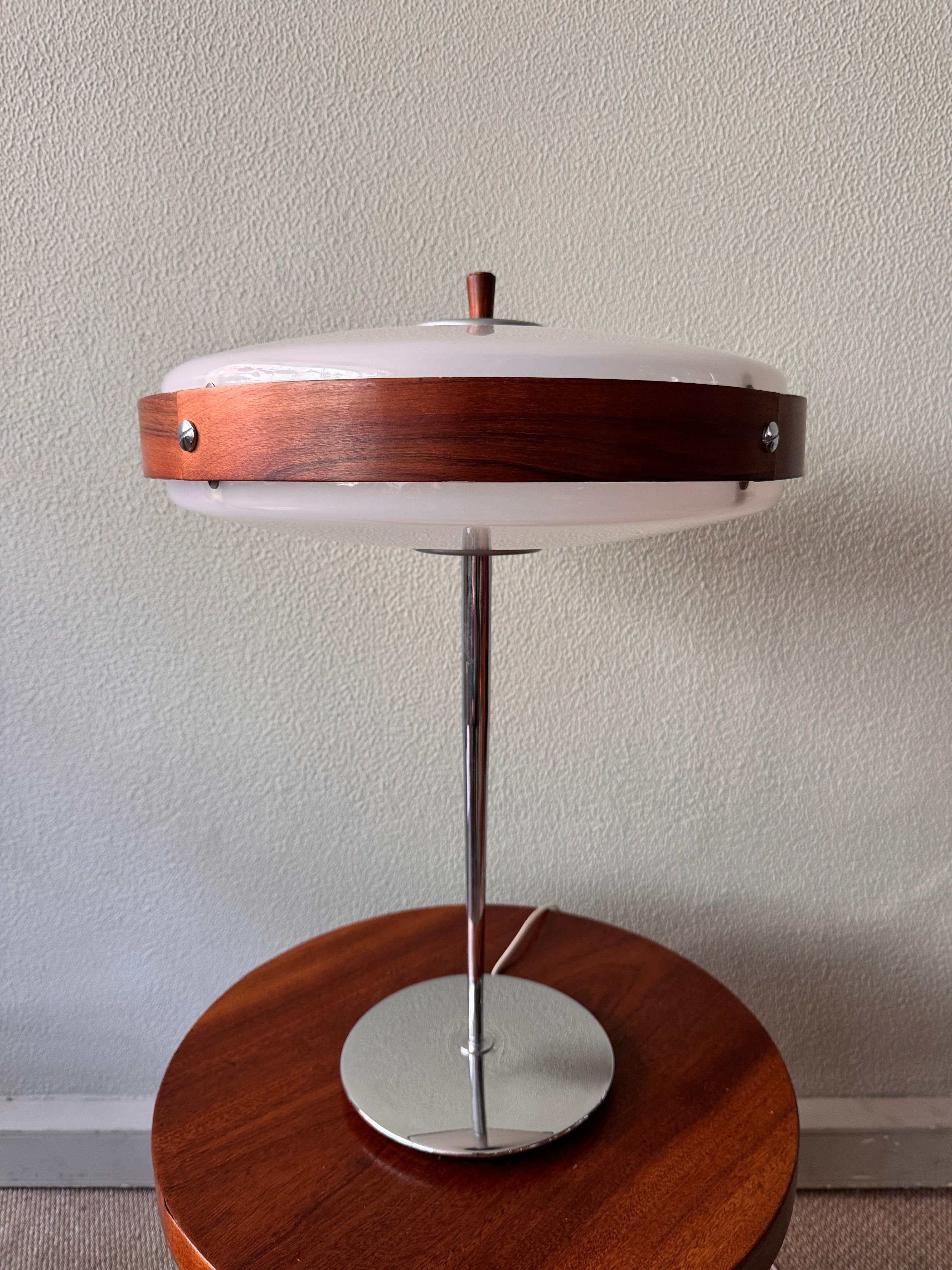 The Eclipse M Table Lamp, designed by Luis Pérez de la Oliva and Pedro Martín García for Fase in 1966, is an extraordinary piece of mid-century modern lighting design. This rare and highly sought-after model is one of Fase's most distinctive