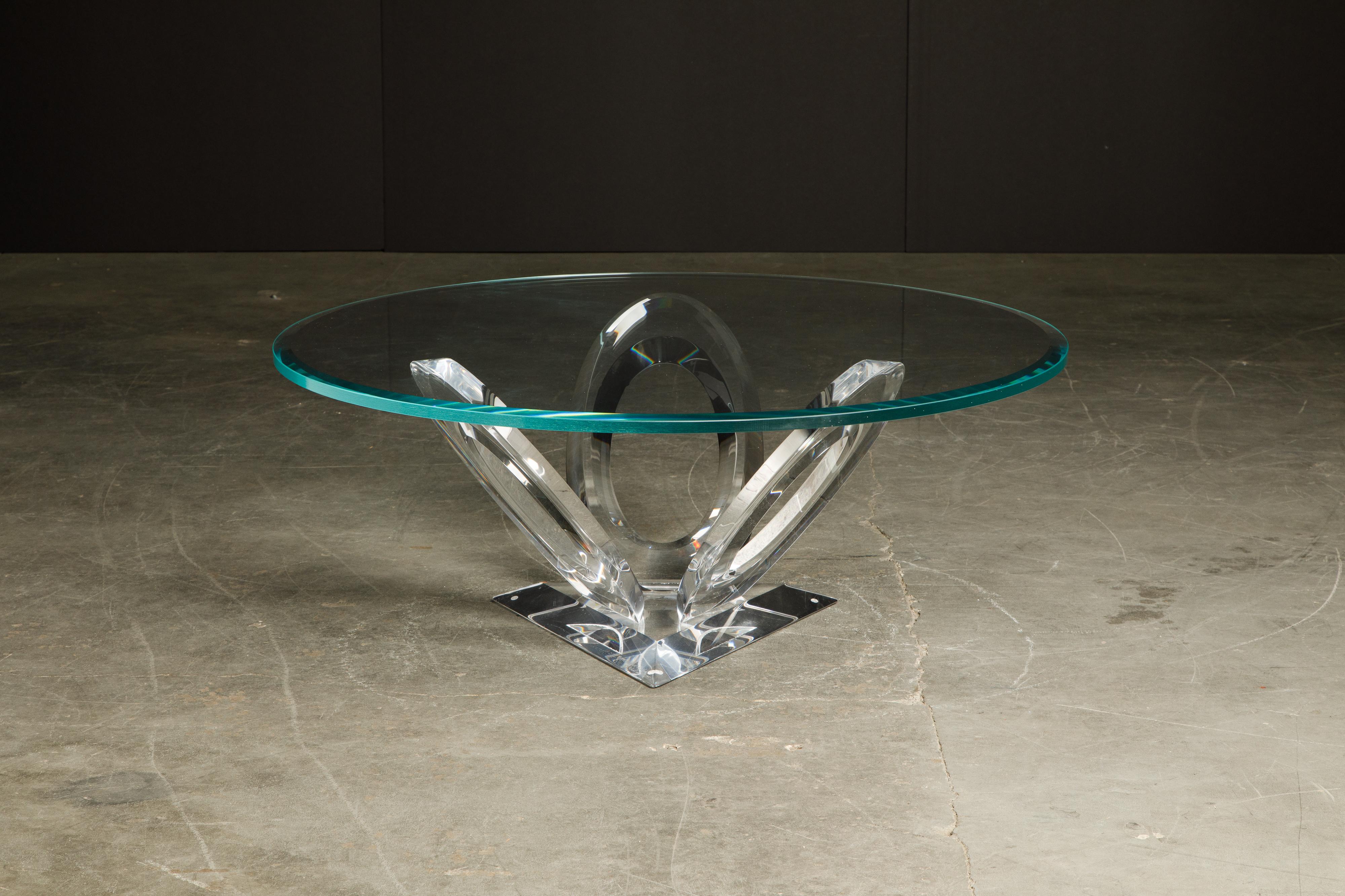 This mesmerizing sculptural coffee table was designed by Russian designer Mikhail Loznikov and was named 'Eclipse of Time'. Sculpted from lucite with a clear glass top, this exquisite piece is an eye-catcher for a designer interior or collector's
