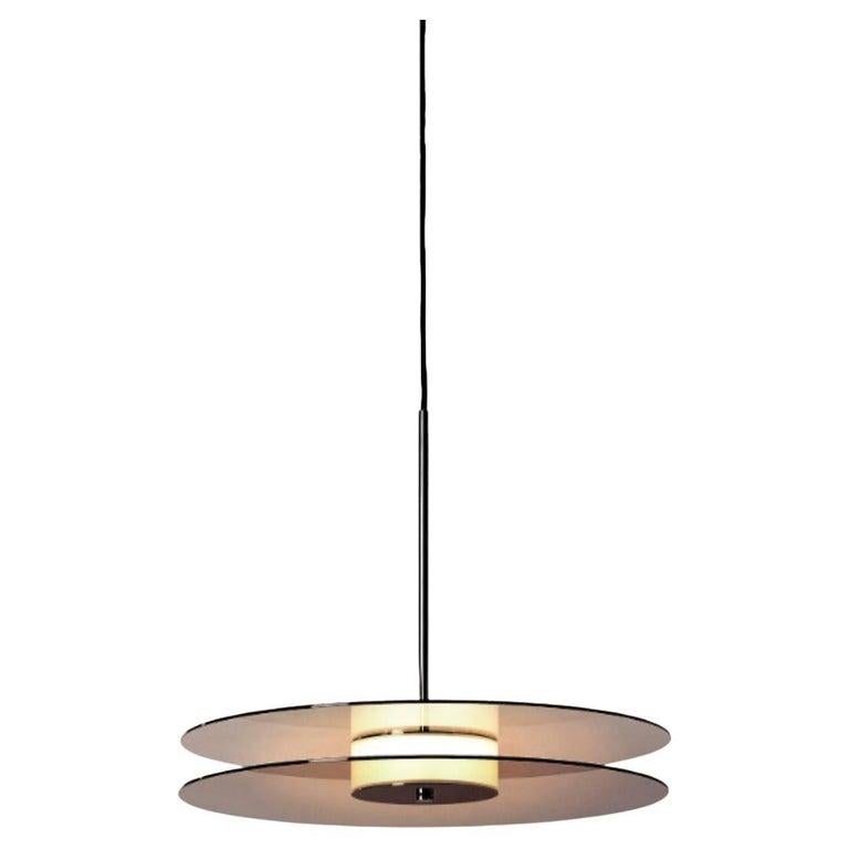 Eclipse pendant light by Dechem Studio
Dimensions: D 50 x H 180 cm
Materials: brass, glass.

Inspired by the 1930s modernist design and Art Deco, Eclipse lamp is comprised of two metallized glass discs with a source of soft light behind the