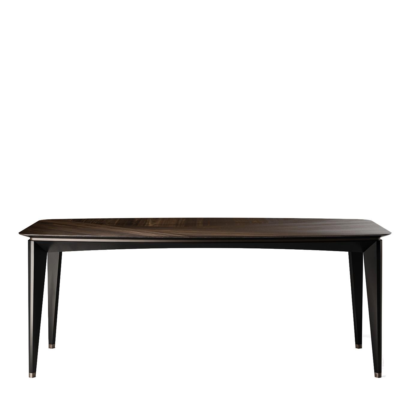 The clean-cut and sleek profile of this captivating table boasts contemporary inspiration that pairs a sleek body with gracefully angled legs. The base is made of lacquered wood with a velvet-like, black finish upon which rests an imposing,