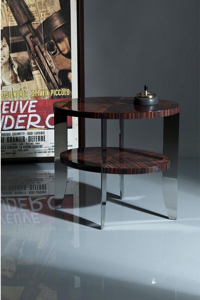 A more slender version of the Eclipse coffee table, but with the same steel/wood trademark junction detail.
Top and shelf in natural macassar 100% gloss
Legs in polished stainless steel.