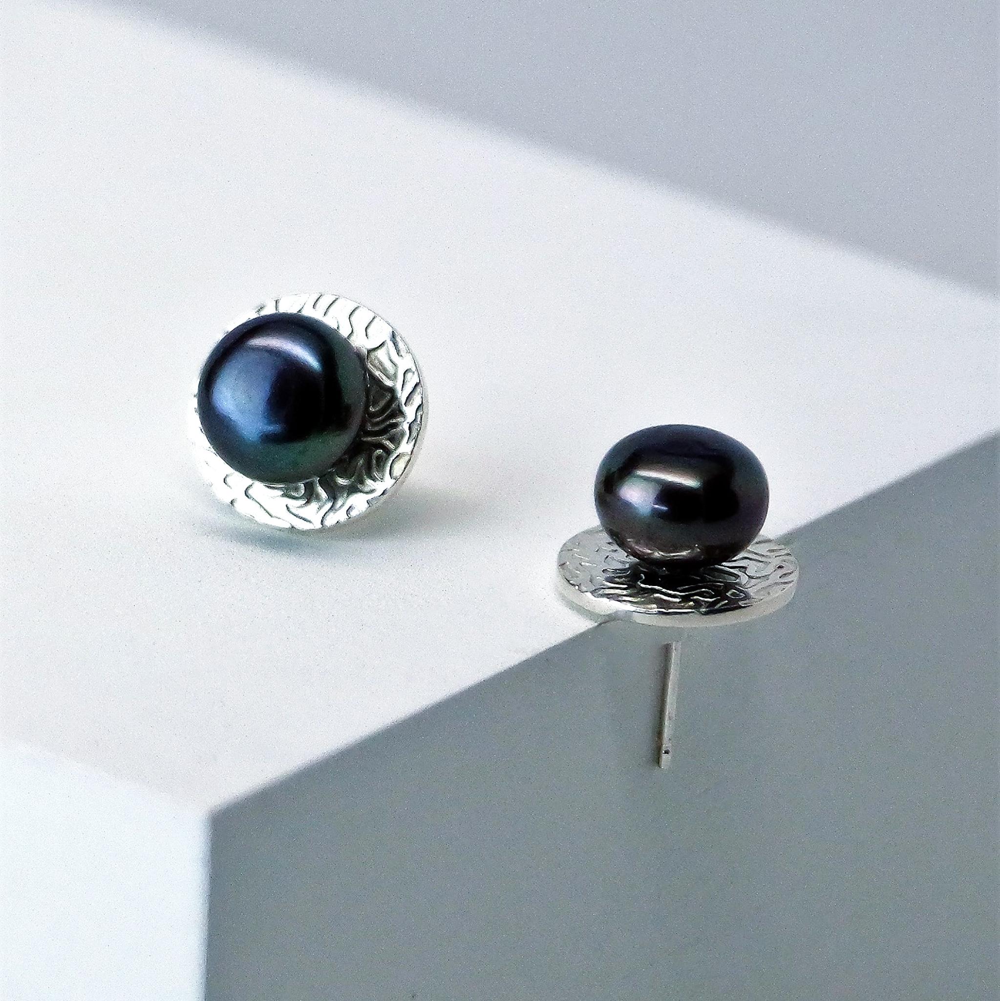 Traditional and yet has a subtle edge, the inspiration behind the Eclipse Studs is about the observer and their source of illumination. Sustainably made in recycled sterling silver and freshwater button pearls, these studs are perfect for everyday