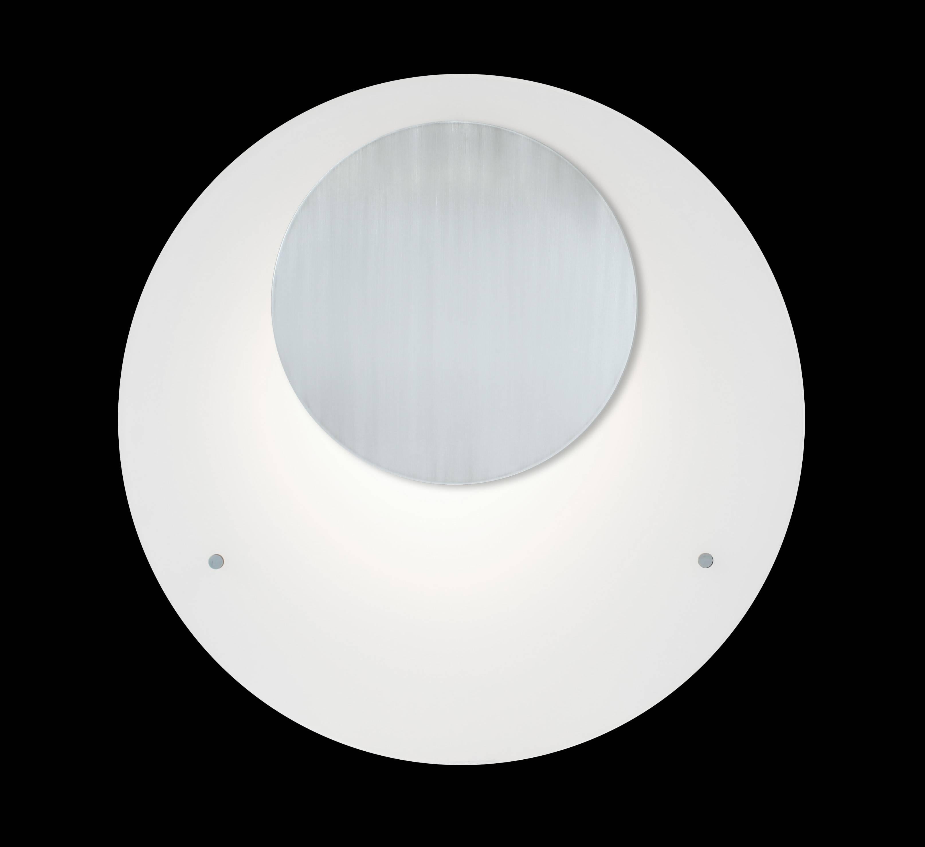 Round aluminium plate over flat white glass panel. Can be used in place of wall art as a decorative feature or large-scale sconce. Interesting when used in pairs. In the manner of Mid-Century Modern design style. LED illuminated 3000K standard color